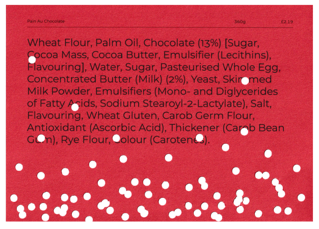 A red page with ingredients listed for a wheat flour, palm oil, chocolate product, including sugar, cocoa, butter, emulgifiers, water, eggs, milk powder, yeast, and other ingredients.
