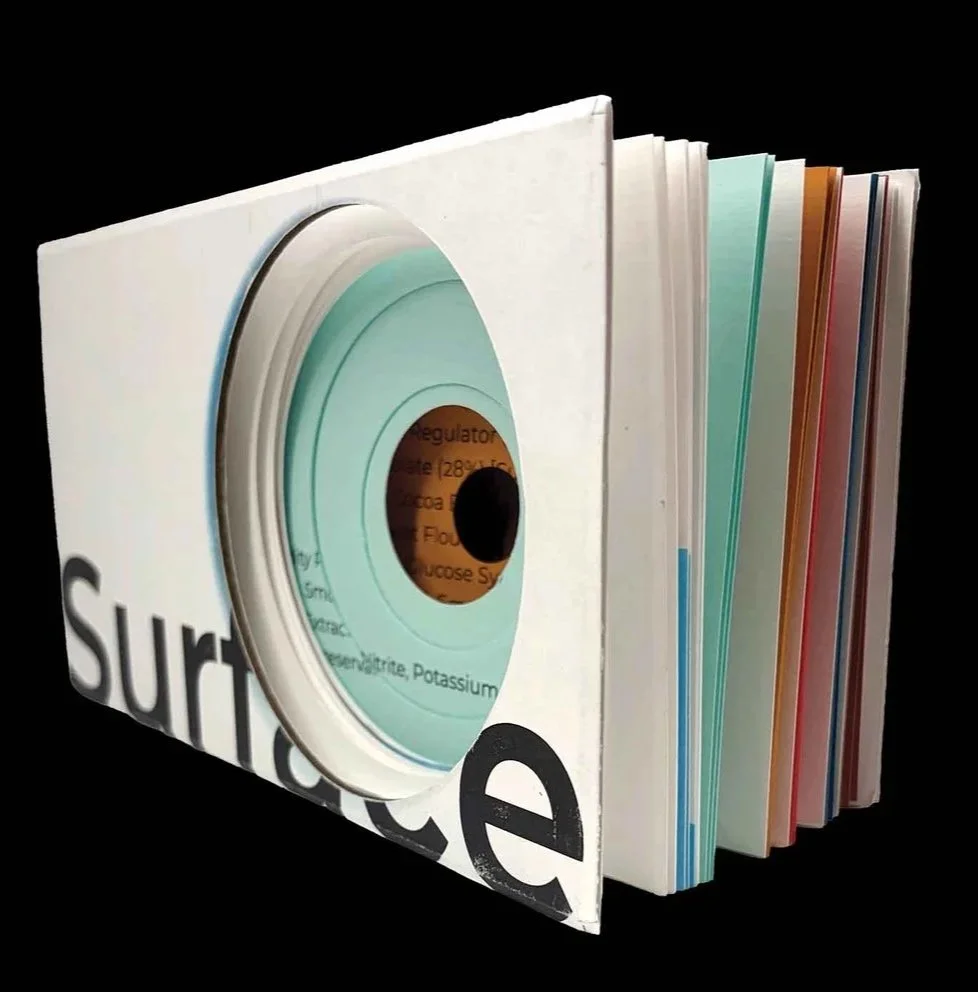 Book with cut out circular voids titles 'Surface'