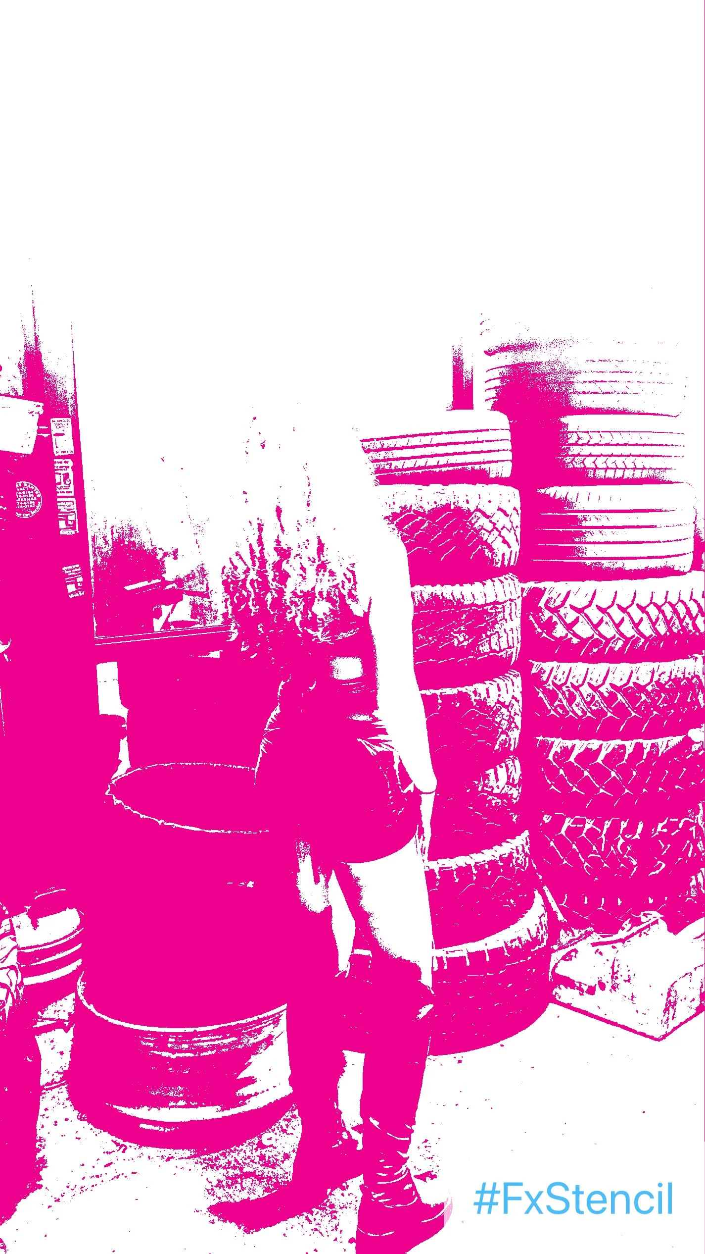 A person with curly hair standing in front of a stack of tires with a staggered pattern in an industrial or tire shop setting.