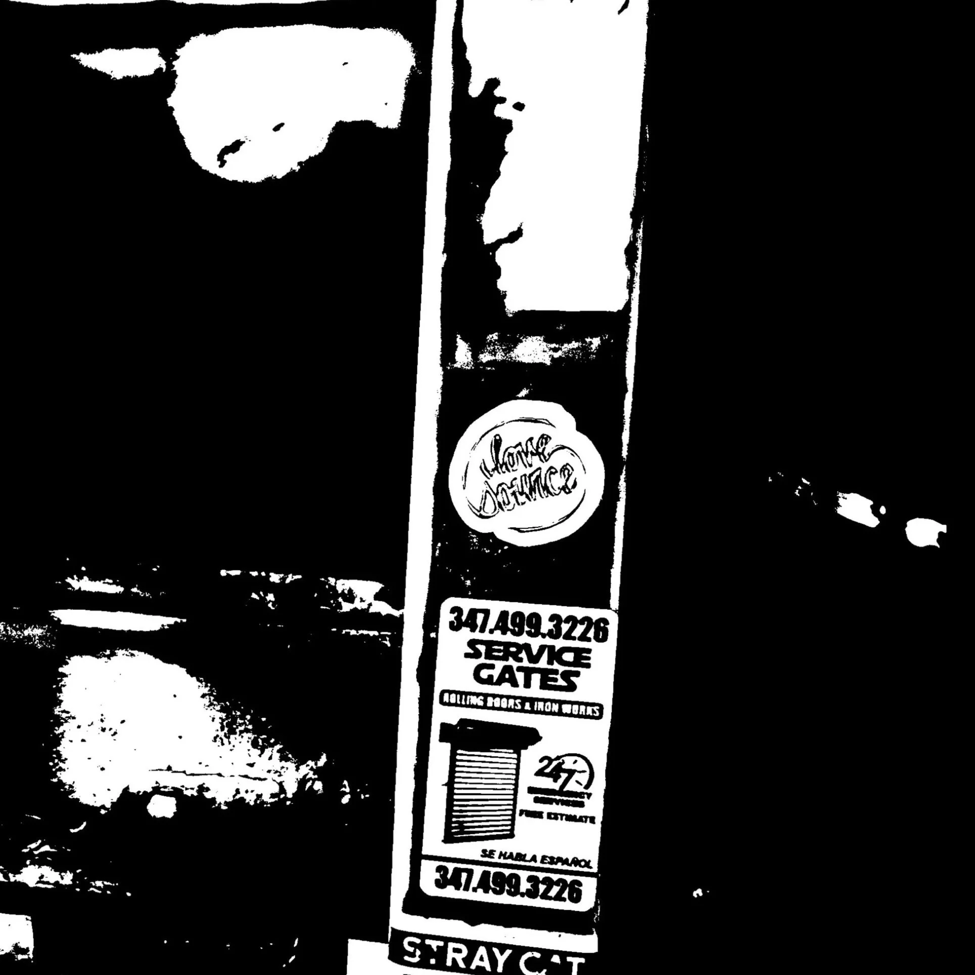 A close-up black and white image of a parking lot signpost, with various parking instructions and telephone numbers. The sign includes directions for service gates, loading docks, and indicates street or lane numbers.