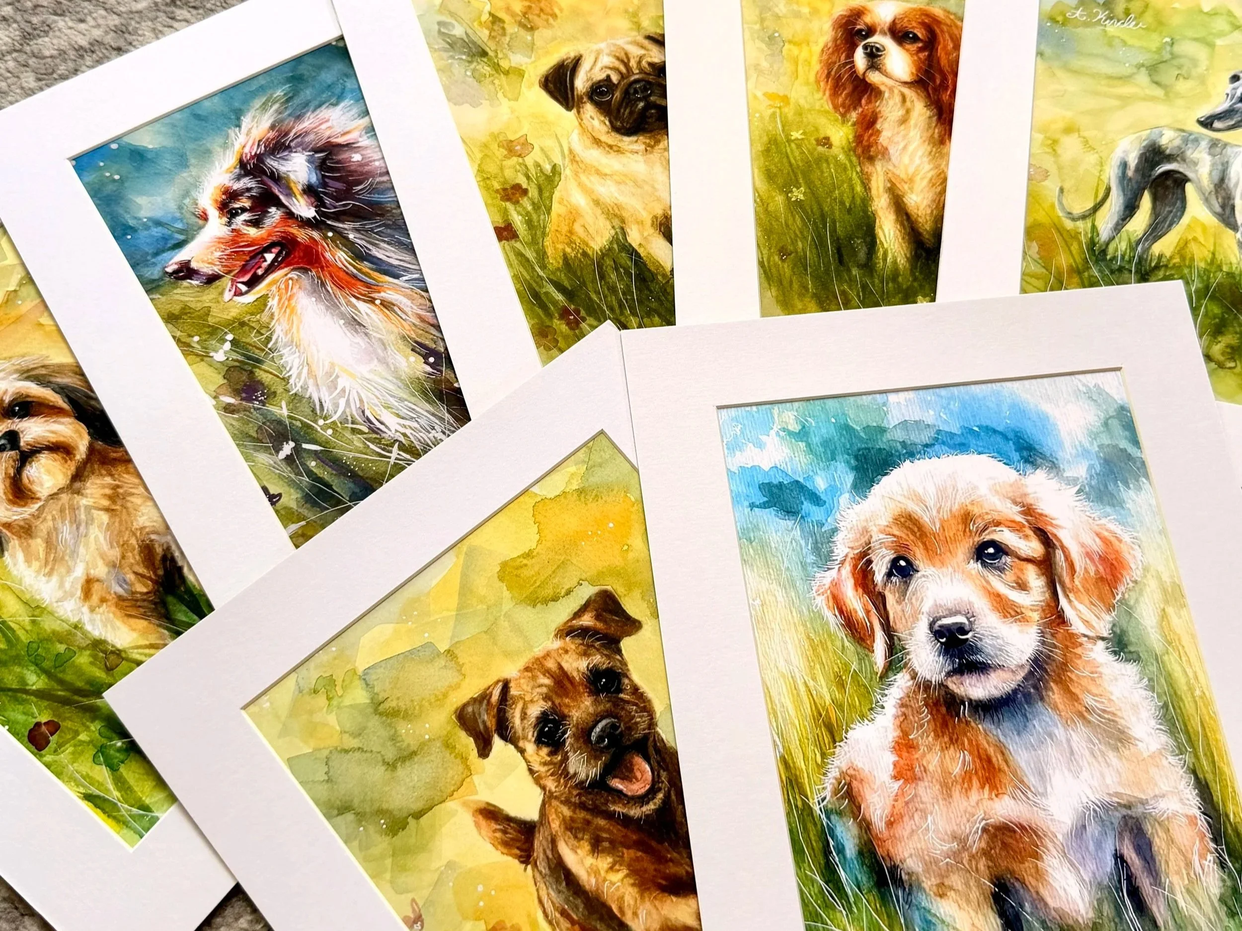 Collection of watercolor-style dog portraits featuring various breeds, set against colorful backgrounds.