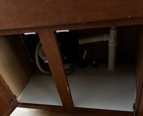 Kitchen sink cabinet area after repair