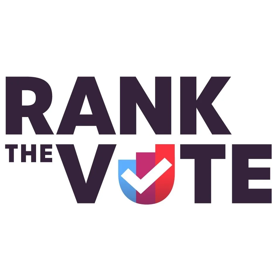 Graphic with the text 'RANK THE VOTE' and a check mark inside a color gradient shield. Vote YES on Measure D for RCV!