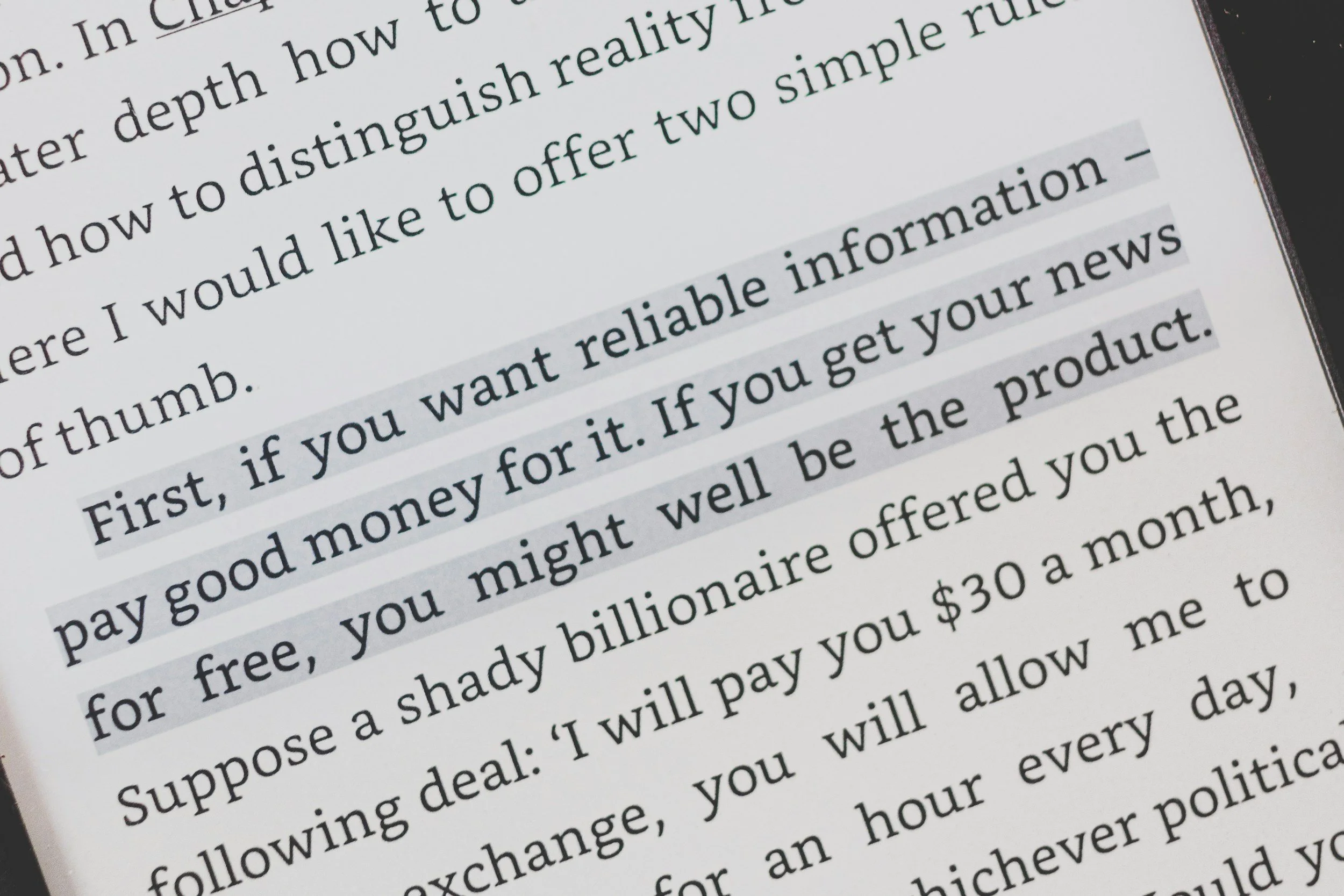 Close-up of a printed page with highlighted text discussing financial advice and investment topics.
