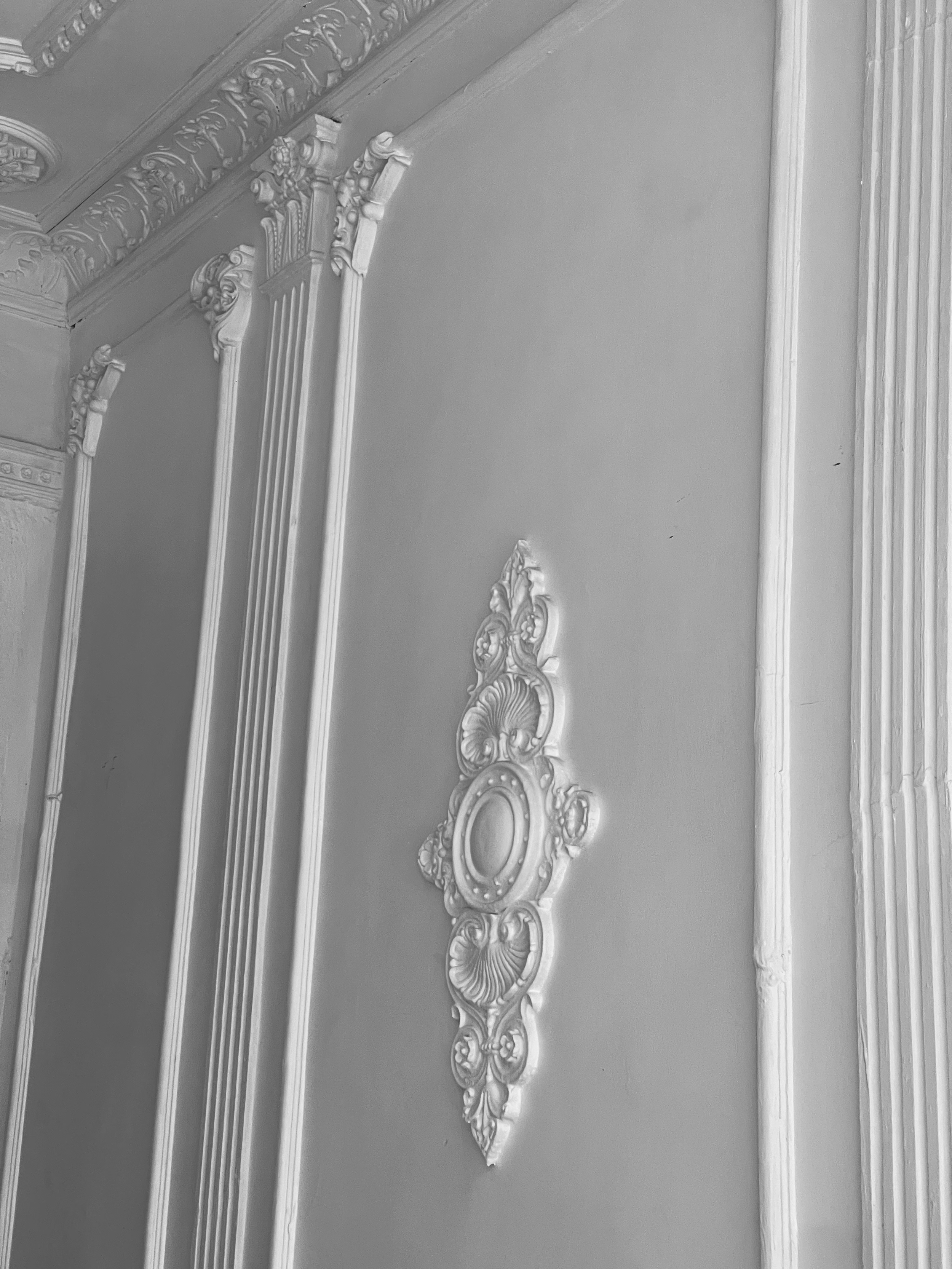 Decorative plaster moldings and cornices on a ceiling corner.