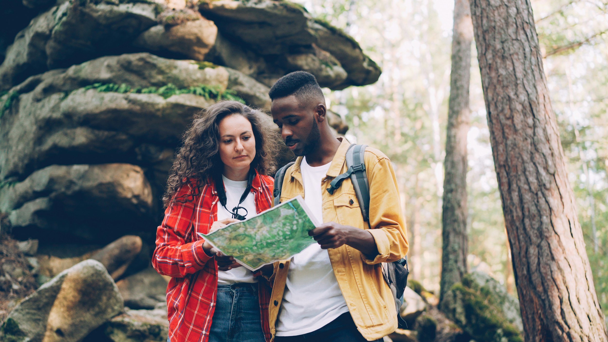 Couple navigating a trail together.