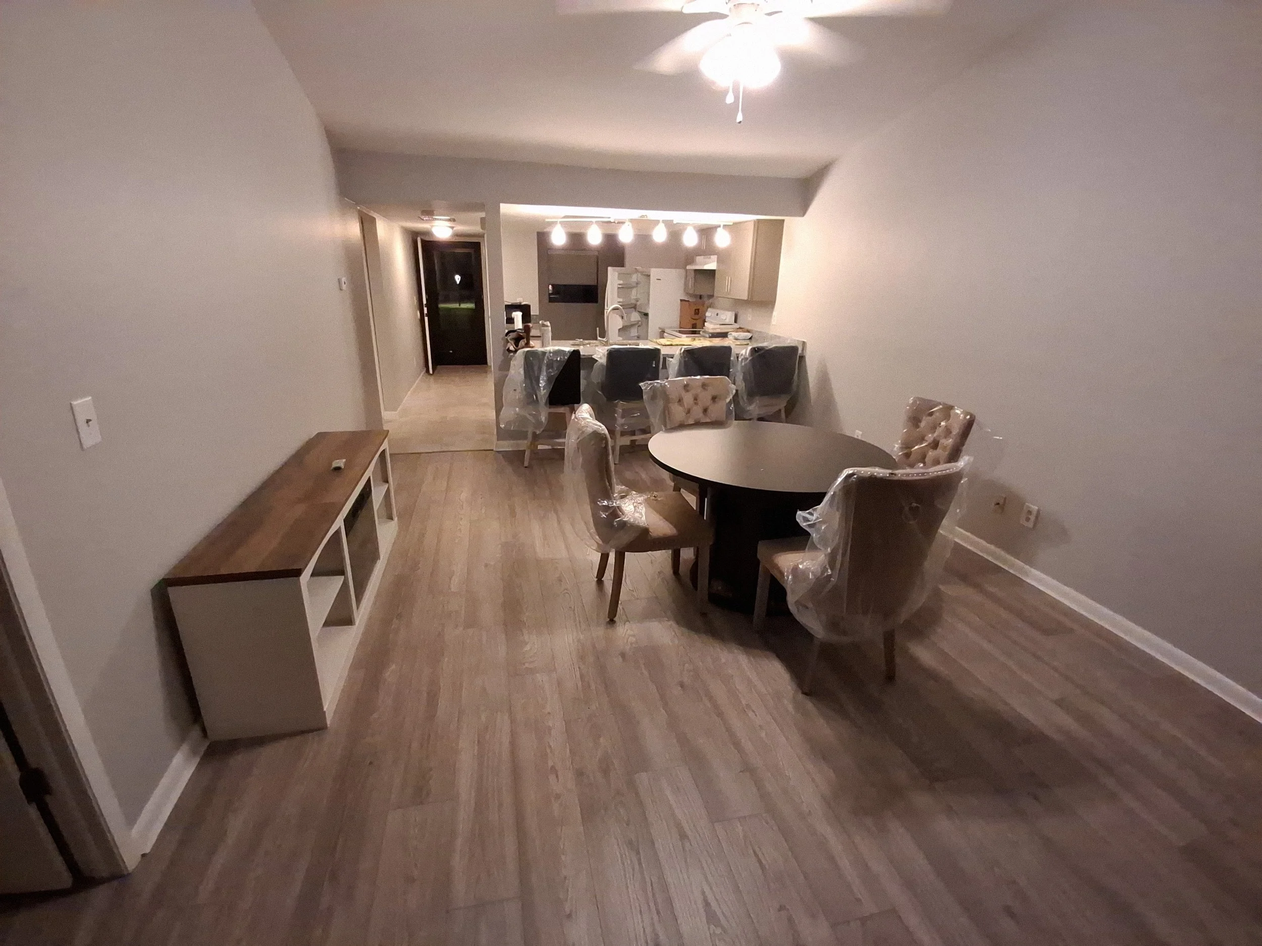 Dining room with a TV console and table and chairs assembled by CBX