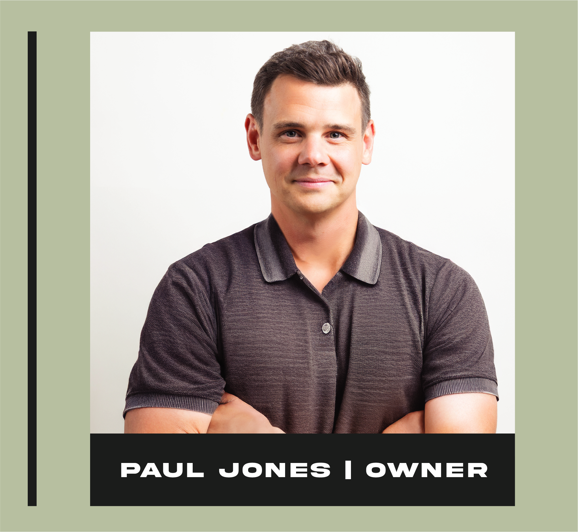 Portrait of a young man with short brown hair, wearing a dark polo shirt, crossing his arms, smiling, with a plain white background. Text overlay reads "Paul Jones | Owner."