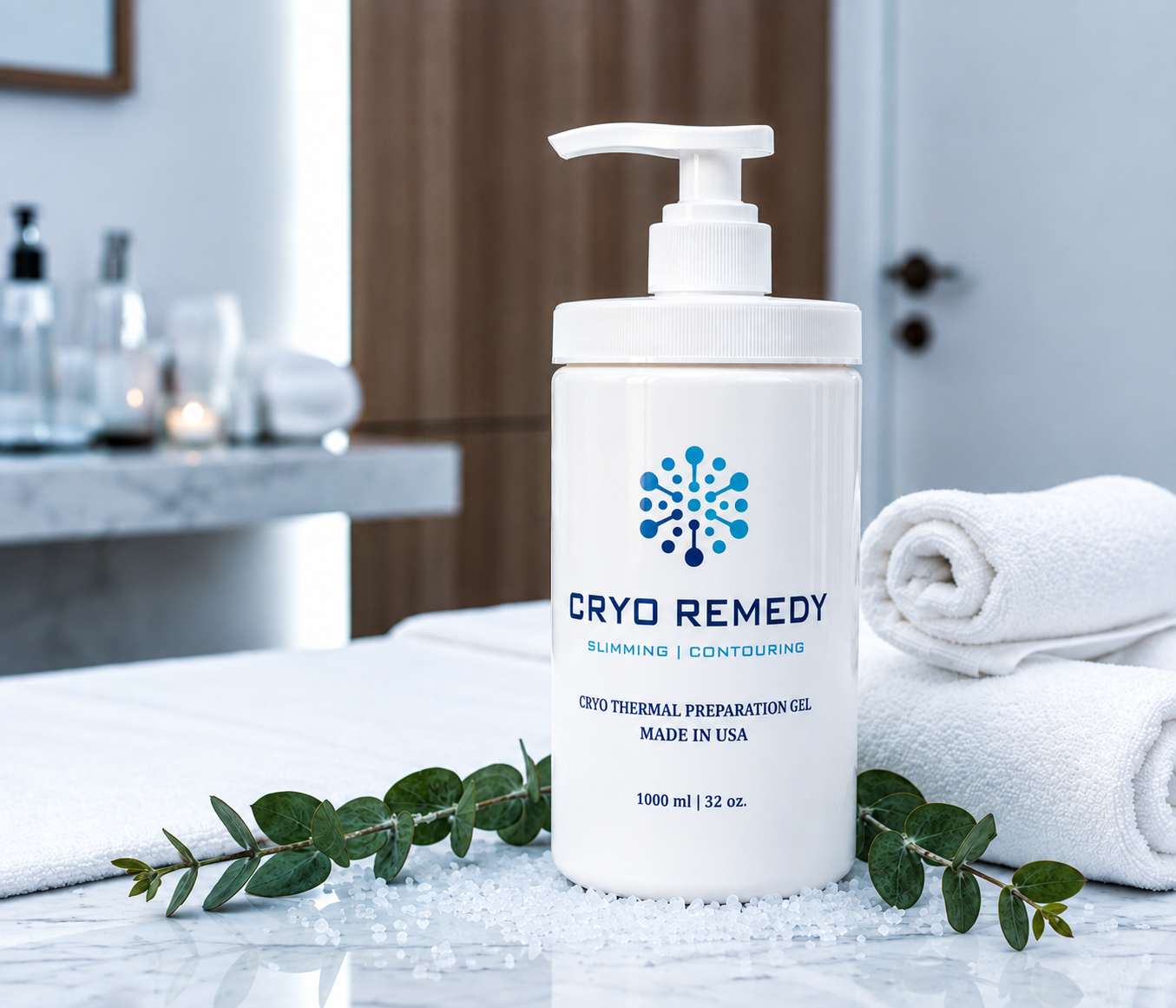 A white bottle of Cryo Remedy cooling gel with a pump dispenser on a marble surface, accompanied by folded white towels and green eucalyptus leaves, in a spa or wellness setting.