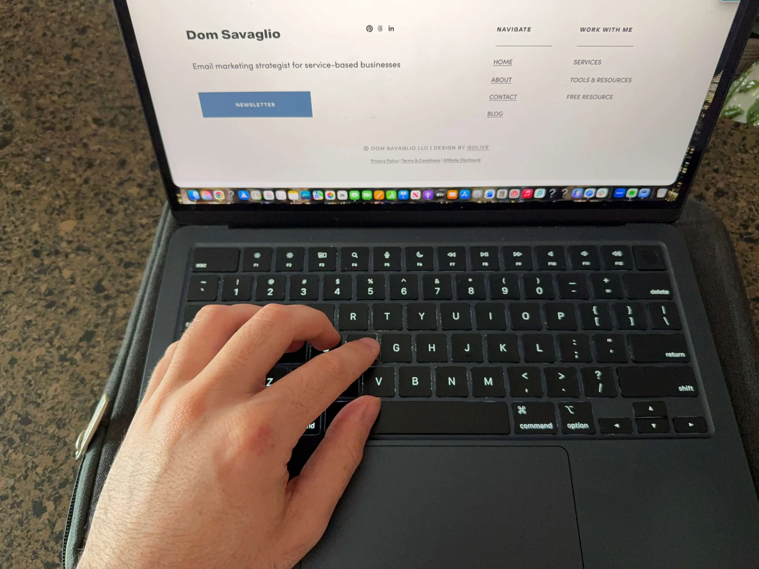 Dom is typing on his computer