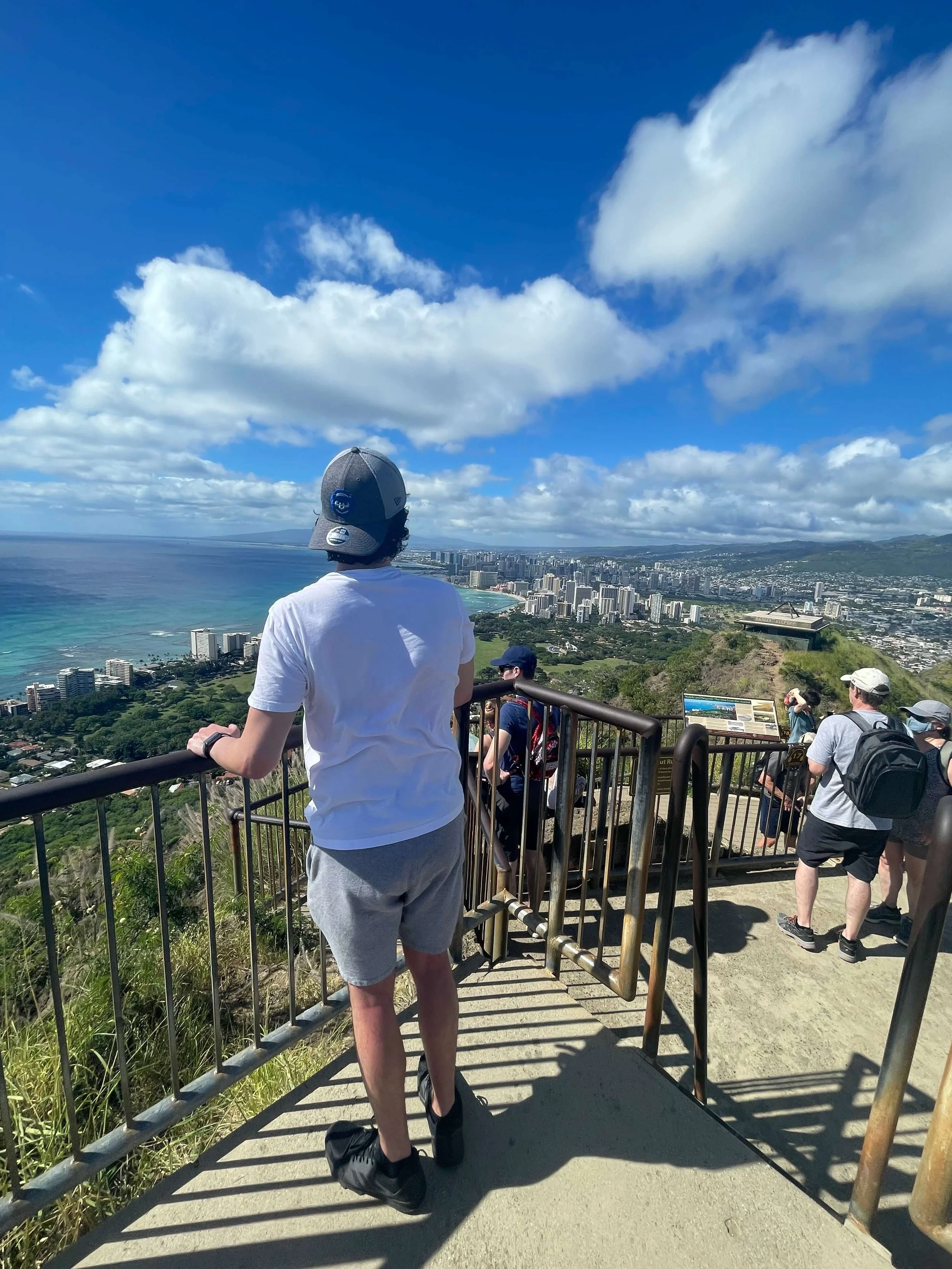 Dom looks out at the skyline of Honolulu, Hawaii from a lookout at Diamond Head