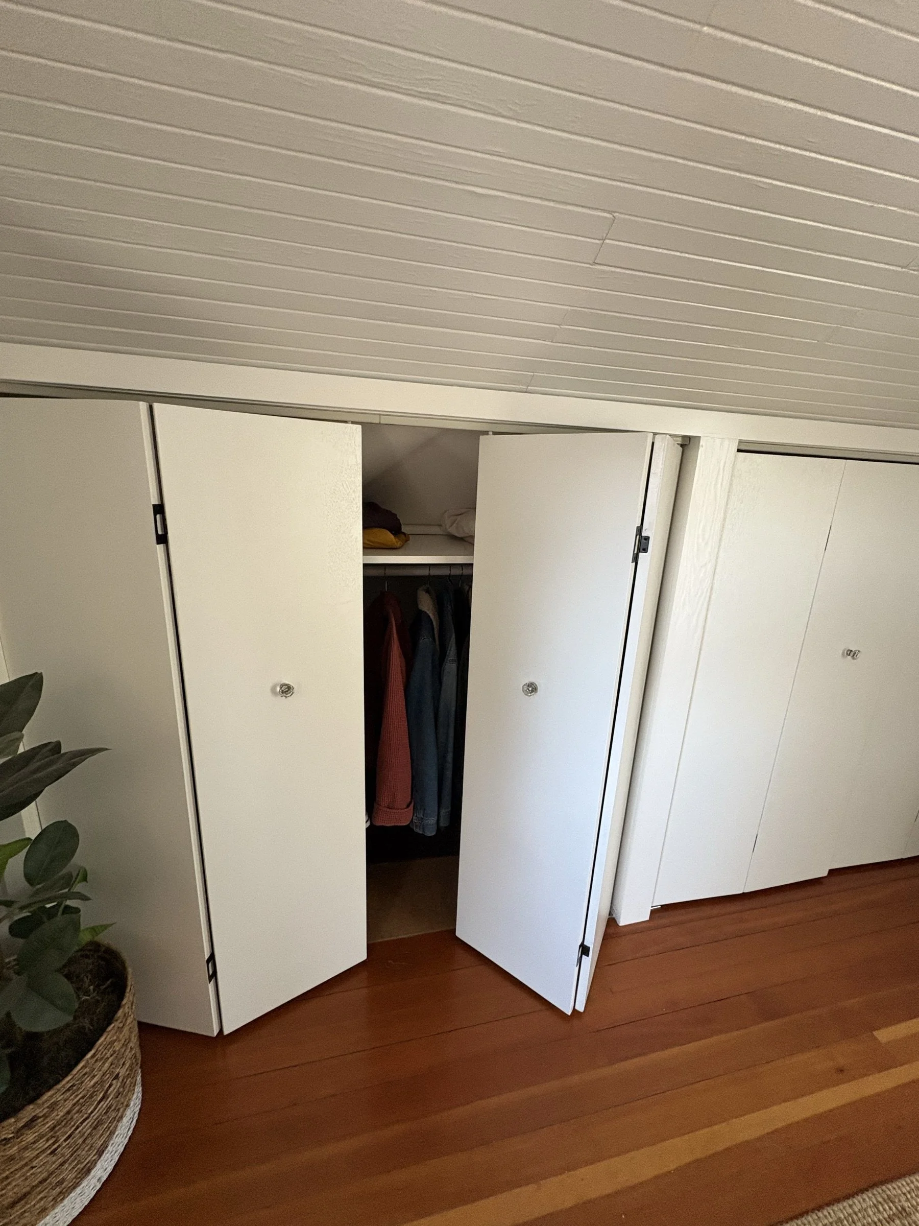 Custom white bifold closet doors, open.