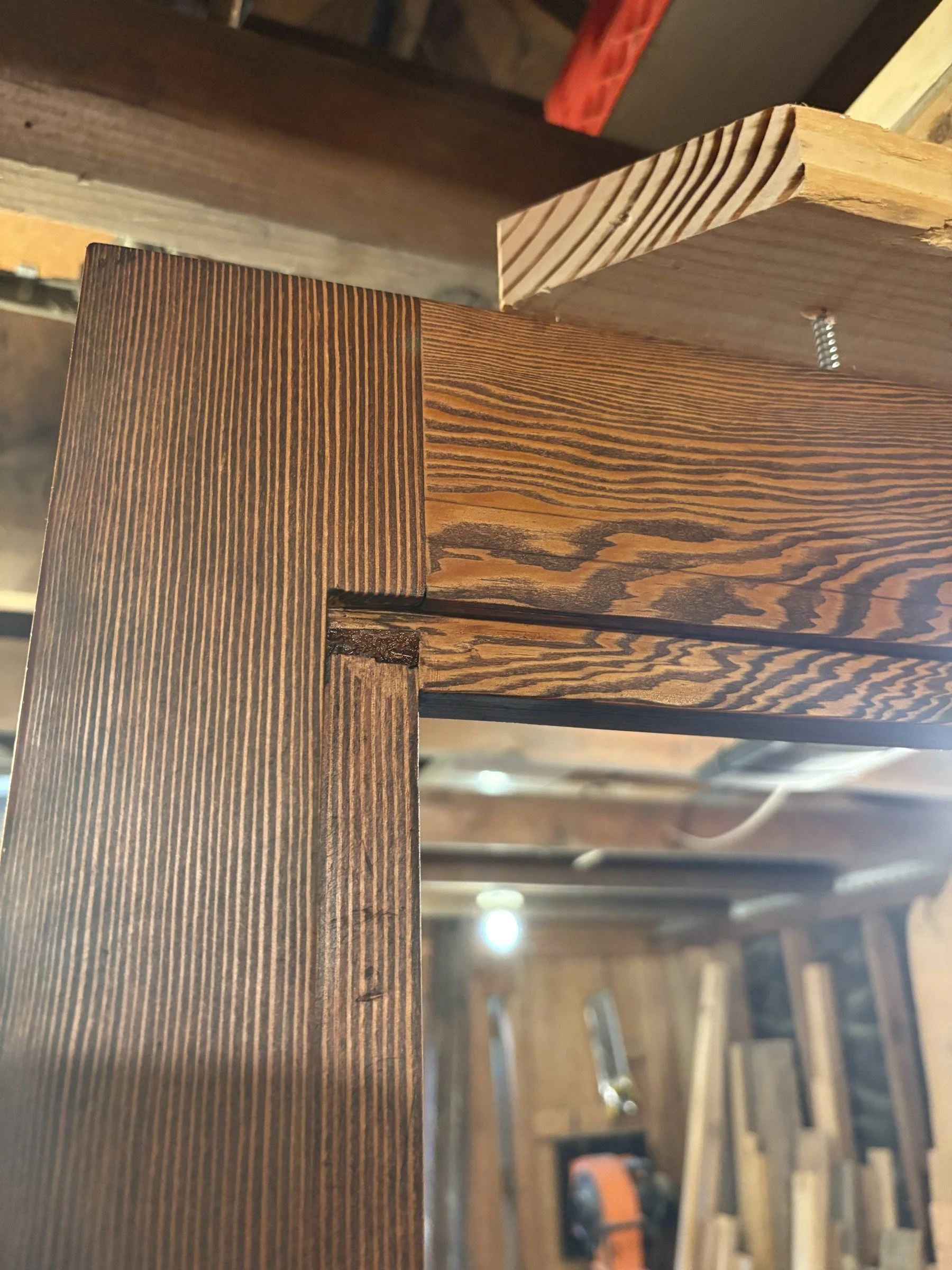 Close-up of the joinery on a custom door in the workshop.