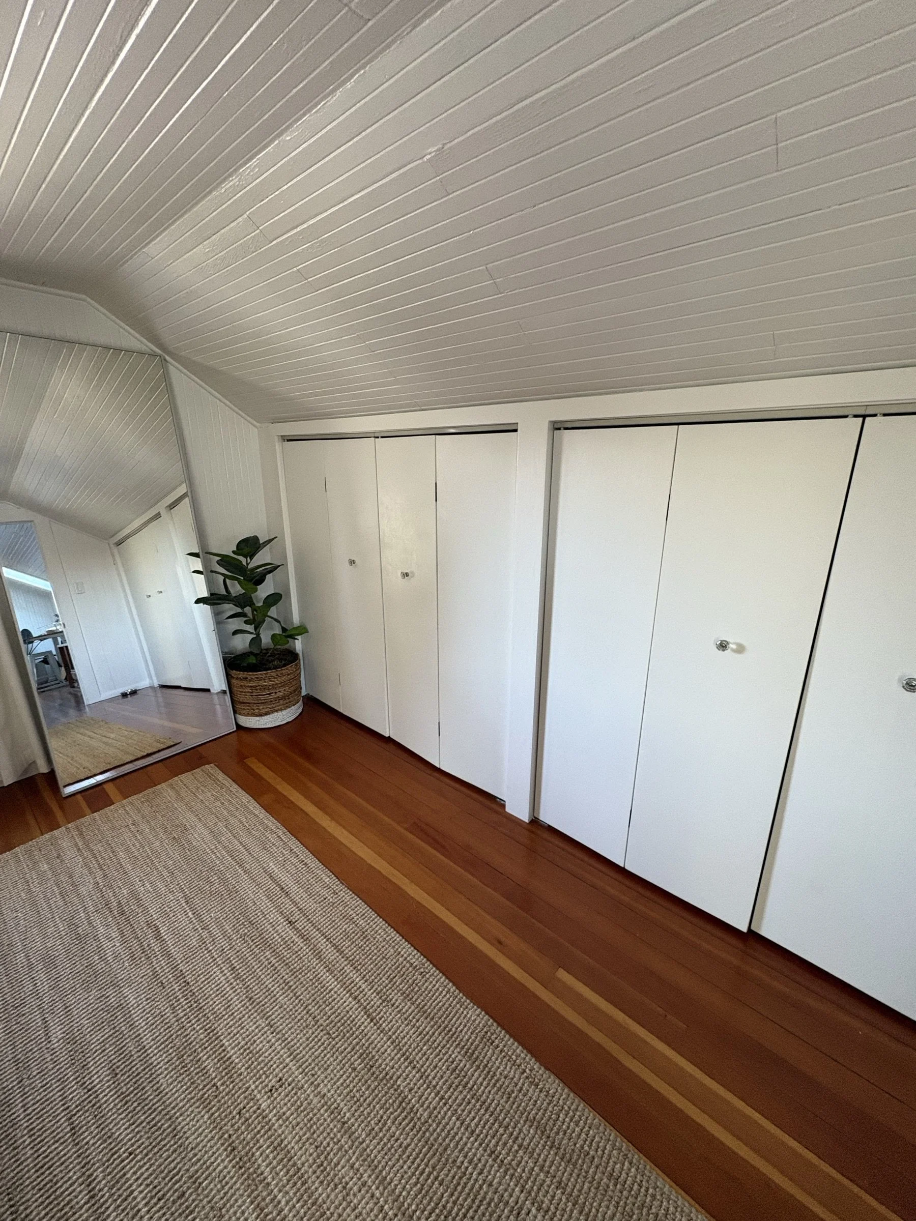 Custom white bifold closet doors, closed.