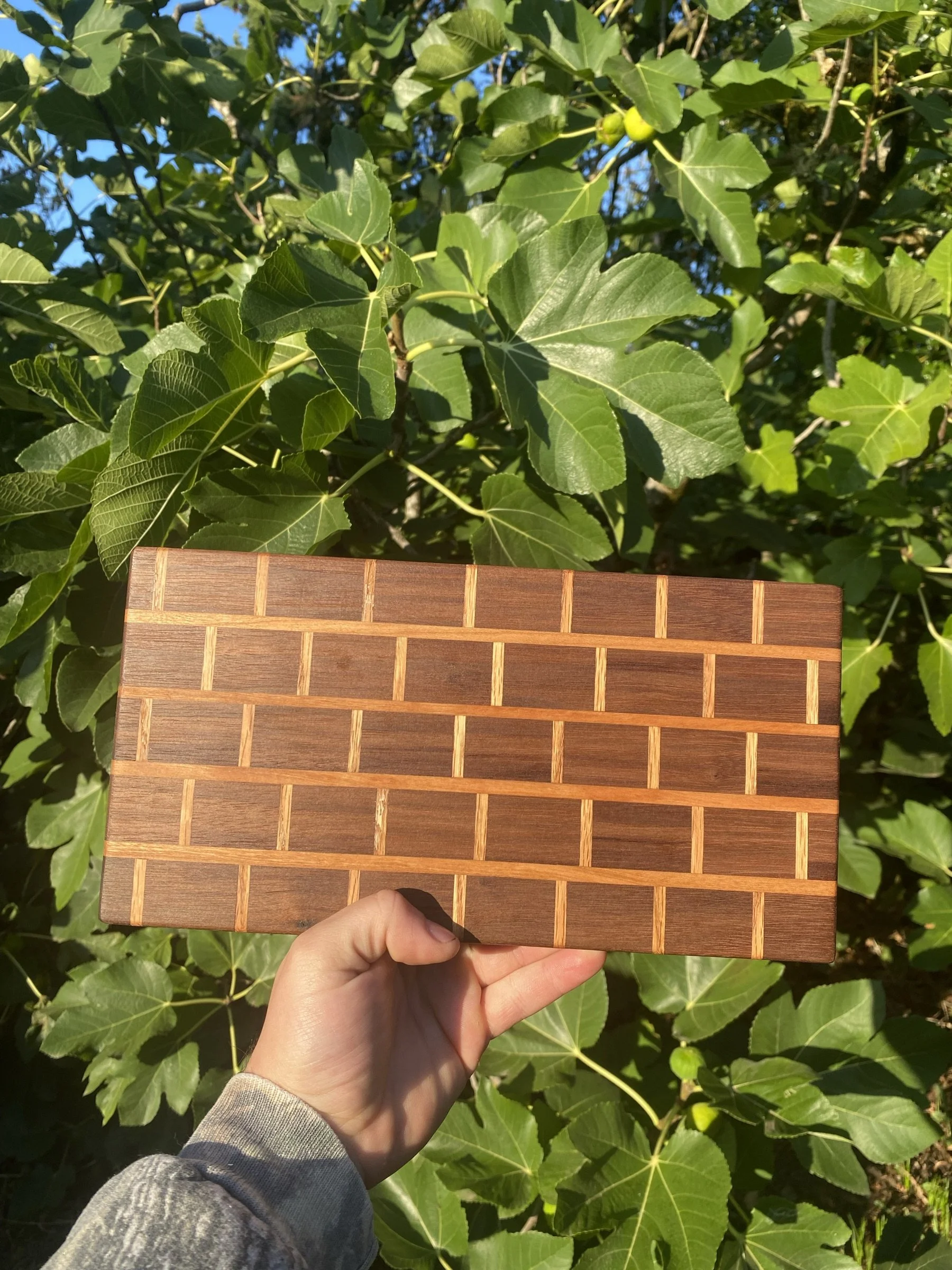 A cutting board with a brick-pattern end-grain inlay.