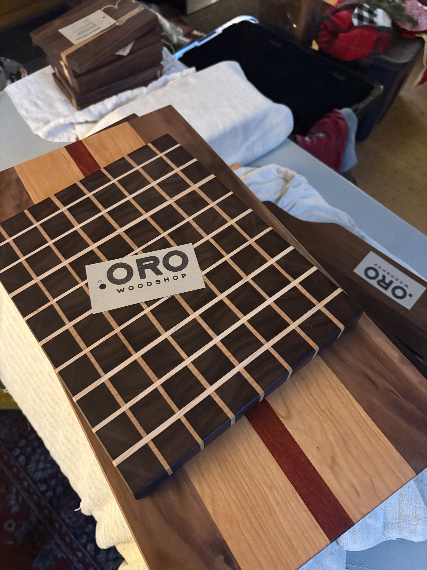 A grid of end-grain boards with an Oro Woodshop label.