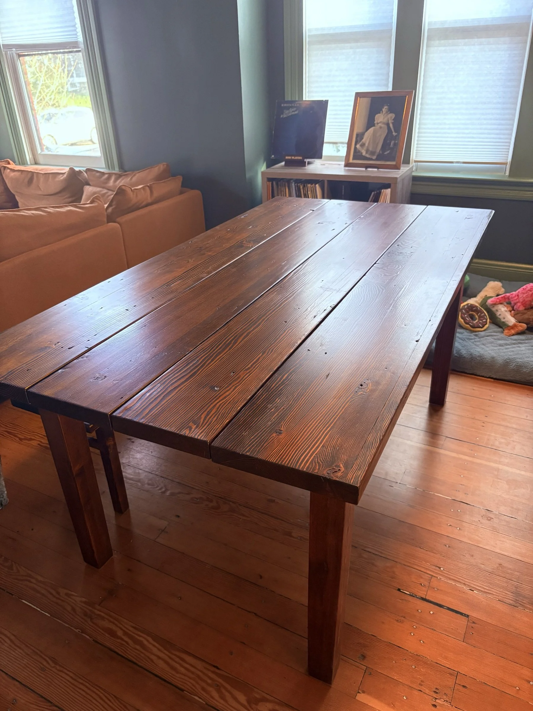 The full farmhouse dining table set in a living room.