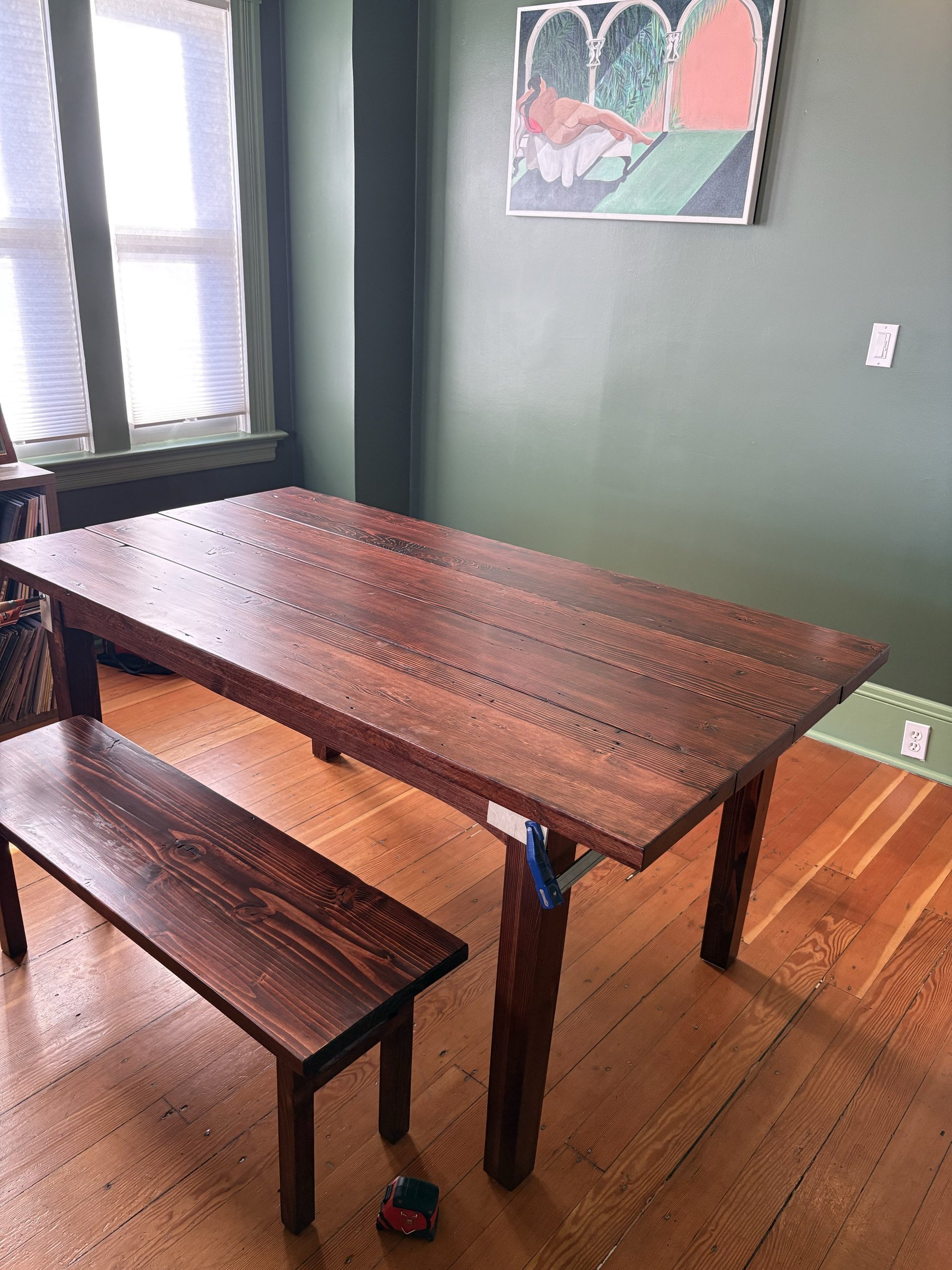 Reclaimed-fir dining table and matching bench in a green-walled room.