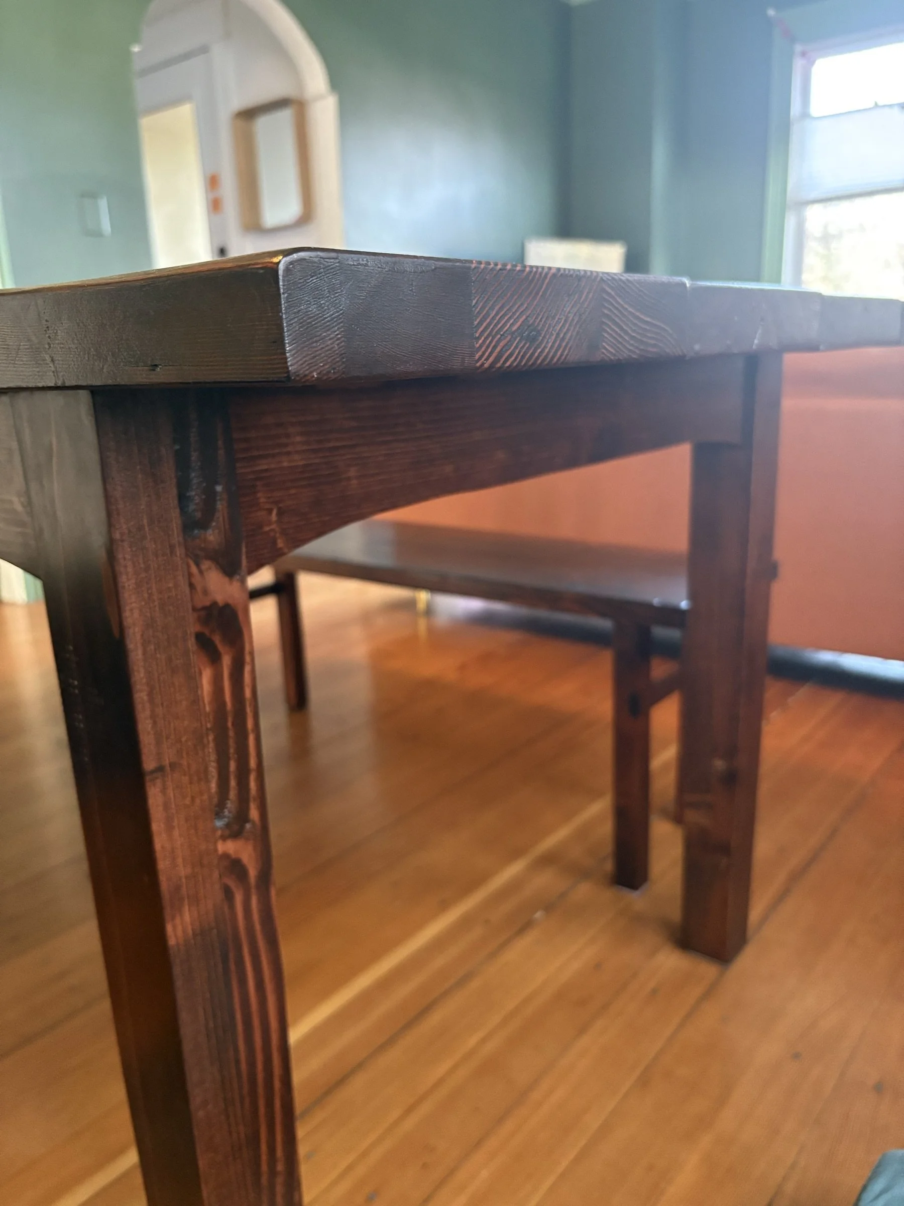 Detail of the tapered leg and apron joinery on the dining table.