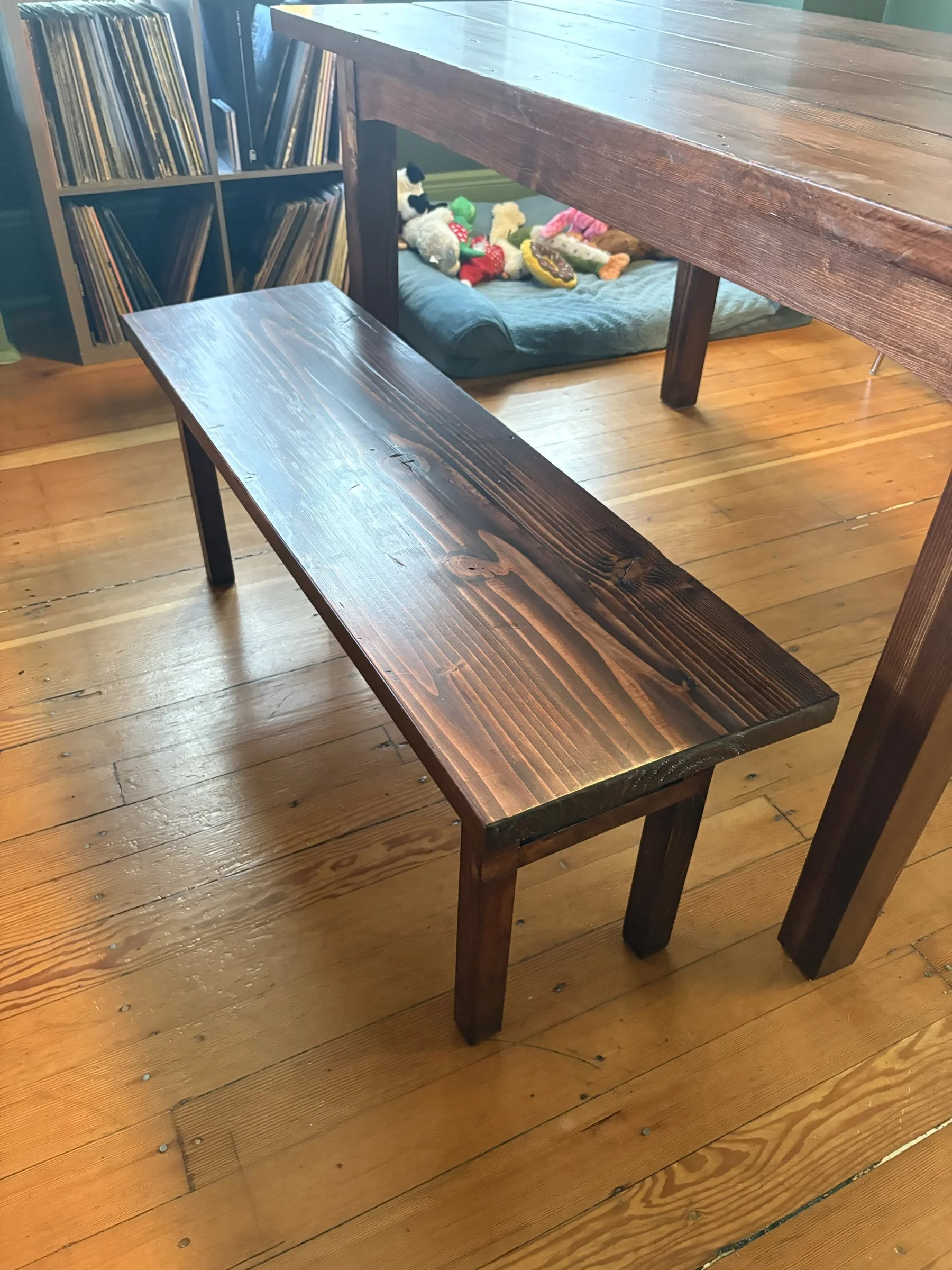 The reclaimed-fir bench beside a record collection.