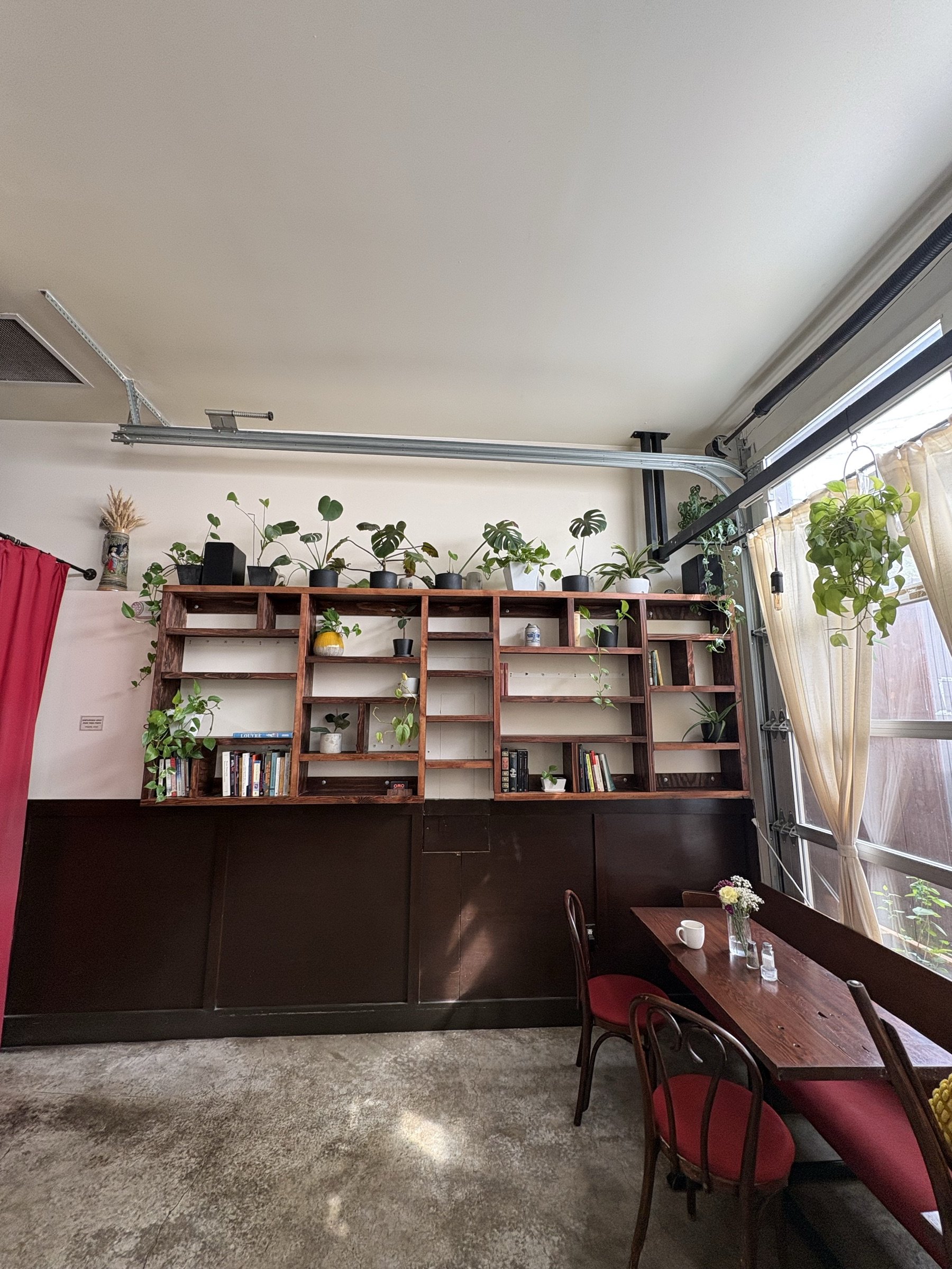 Wide view of the 11-foot community bookshelf at Fressen Artisan Bakery.