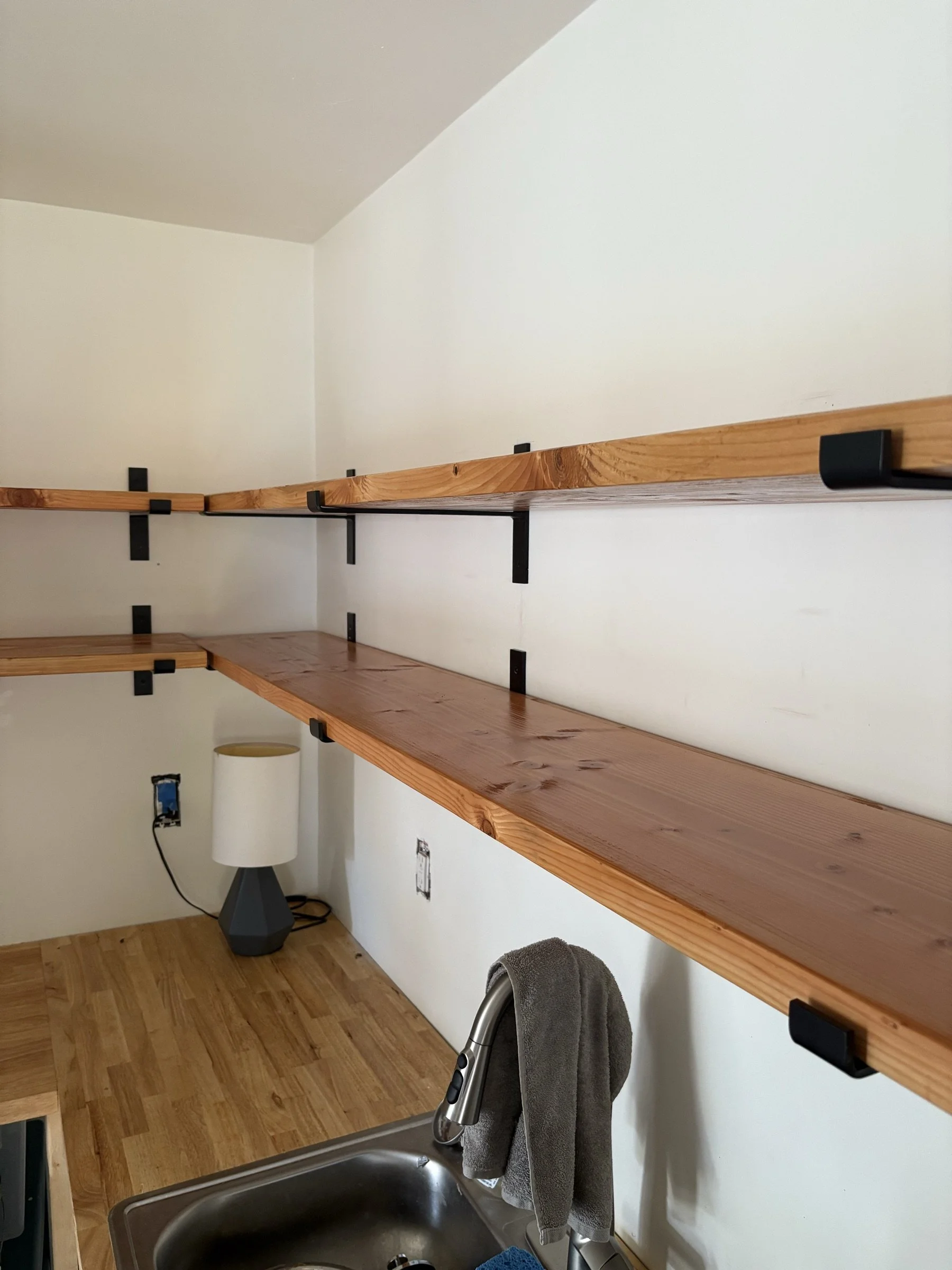 L-shaped wall shelves seen at an angle.