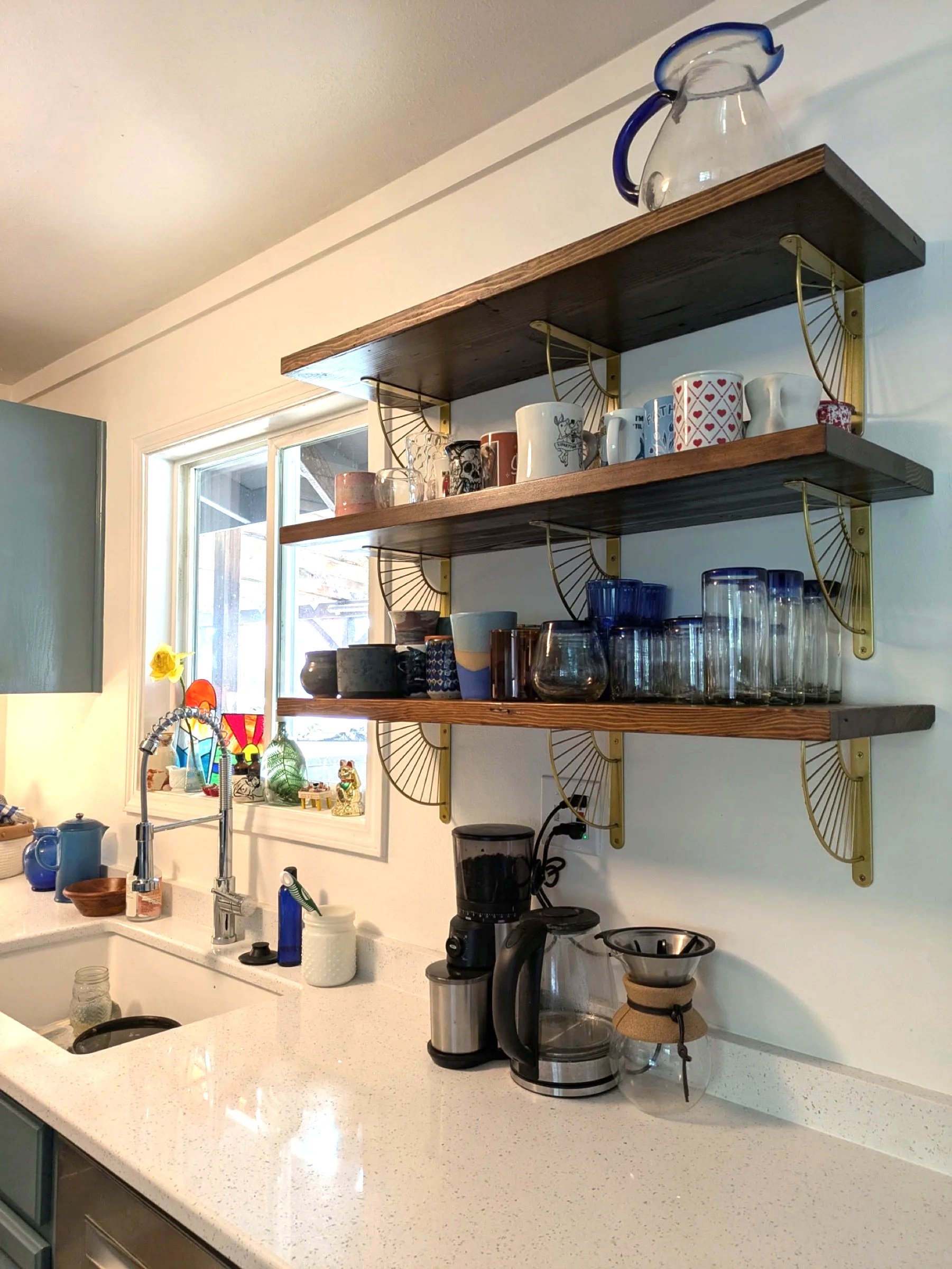 Kitchen wall shelves holding mugs and glasses.