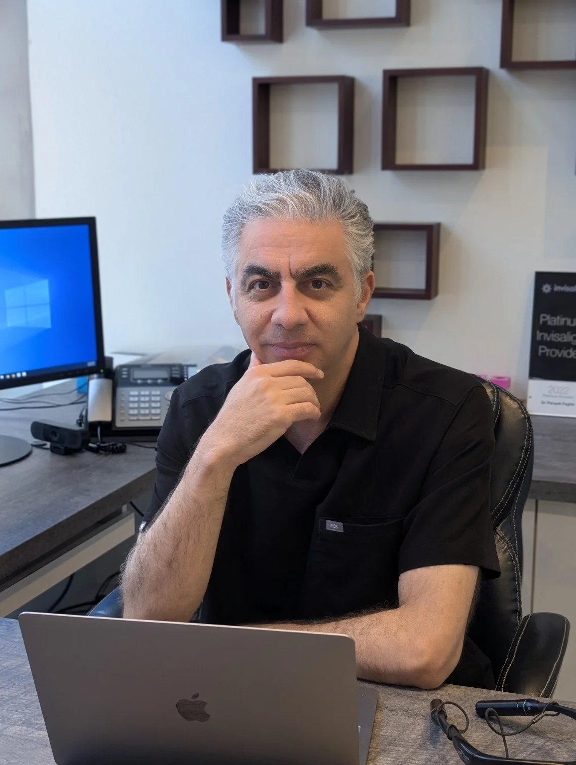 Dr. Maziar Shahzad Dowlatshahi in a consultation setting at Fort Dental Clinic.