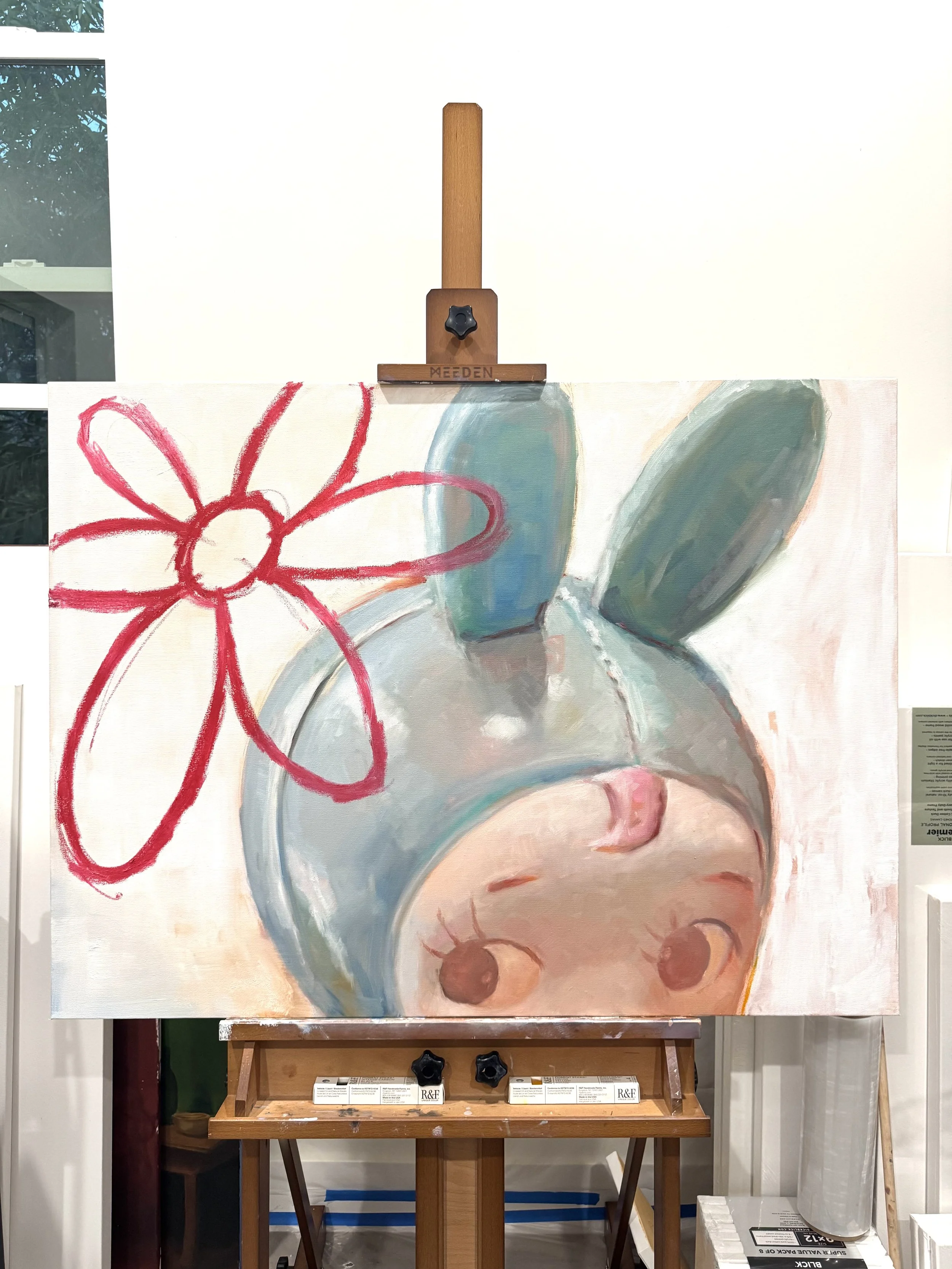 Painting of a cute character with a large head, likely a mouse, with big ears, closed eyes, and a small nose, featuring a red outlined flower with a red stem to the left side of the head.