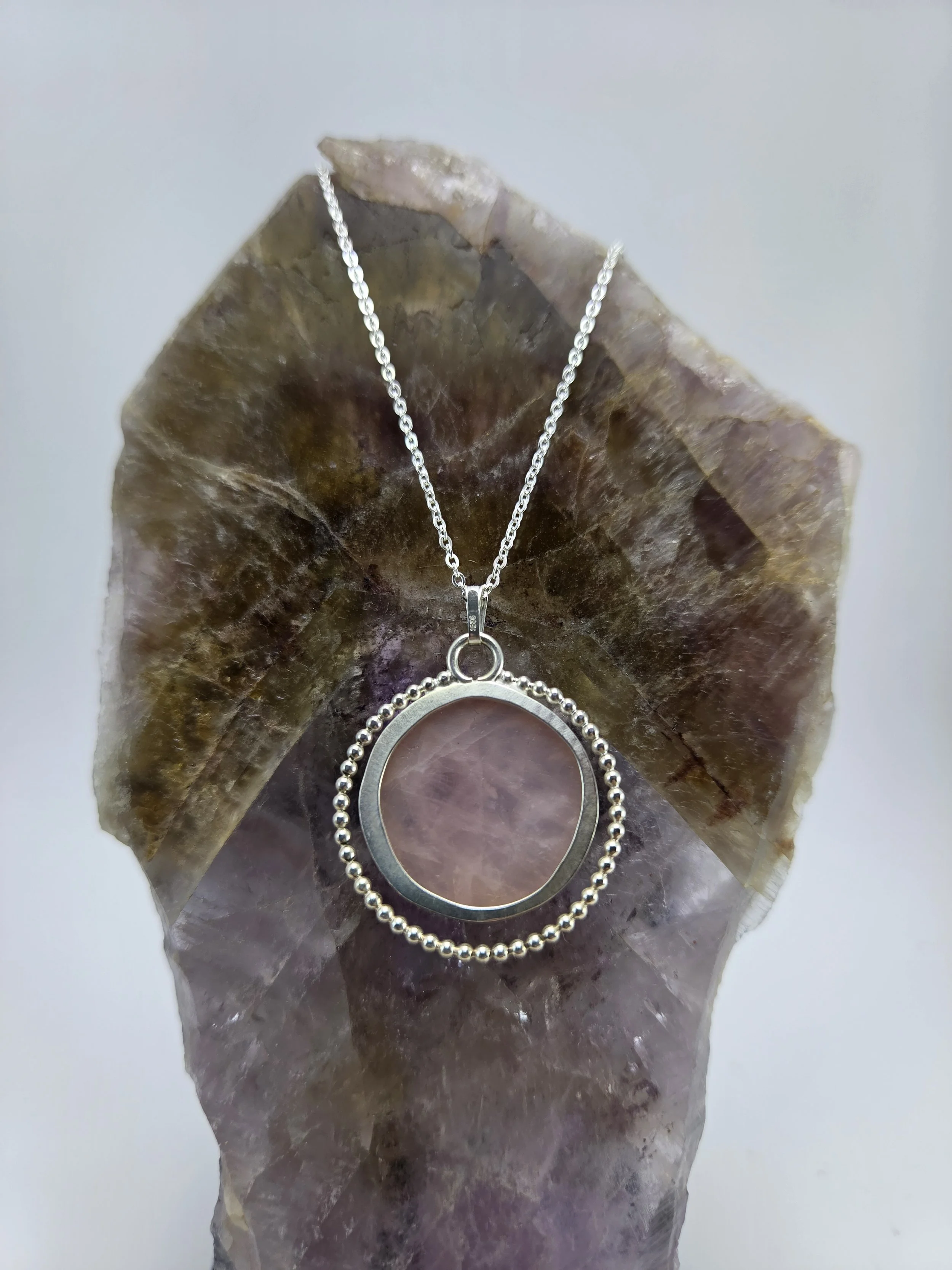 Back of rose quartz pendant necklace with beaded silver wire embellishment