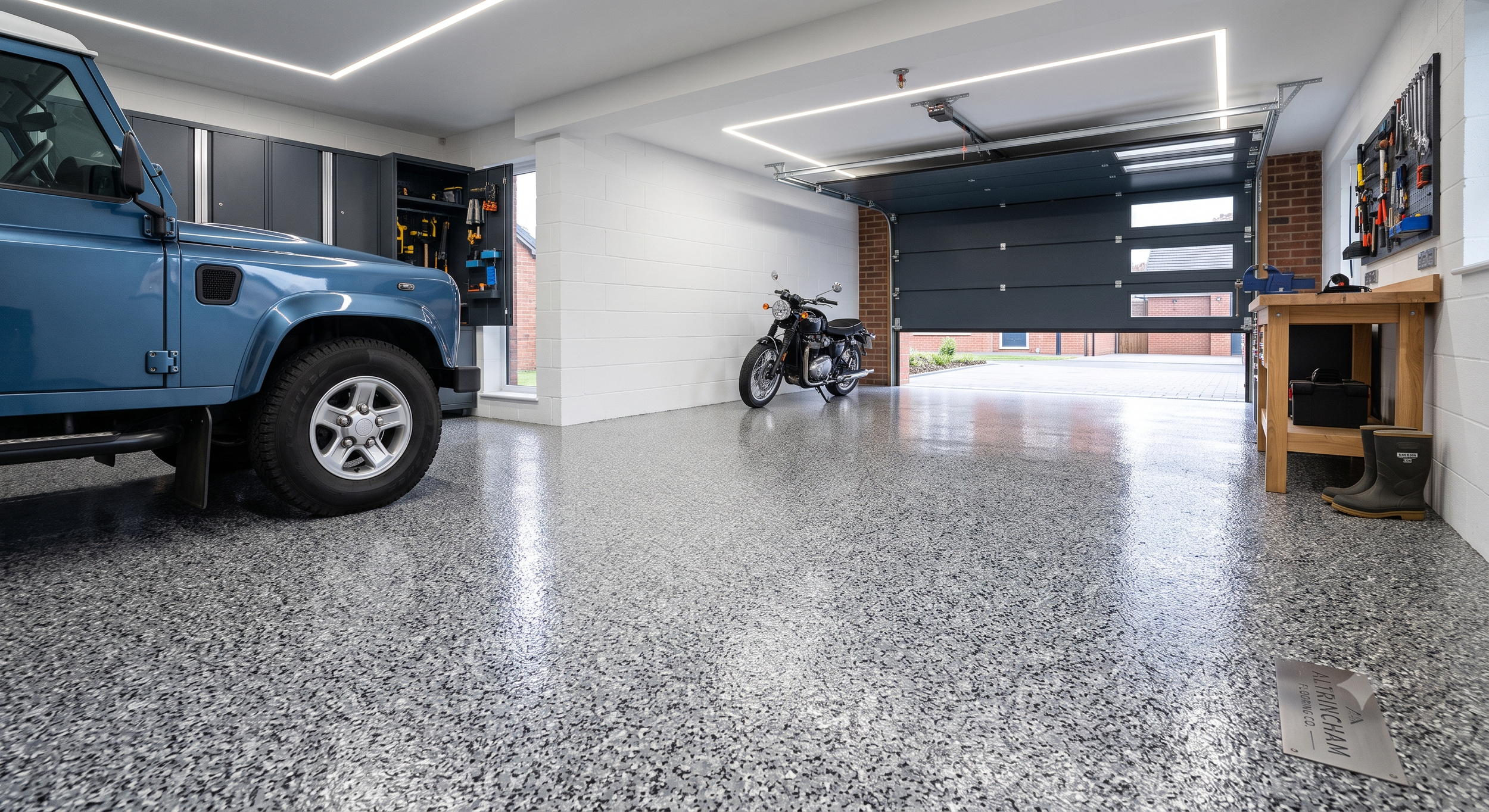 Polyaspartic garage flake resin floor in Altrincham, Greater Manchester. Anti-slip, stain-resistant, and chemical-proof epoxy garage transformation.