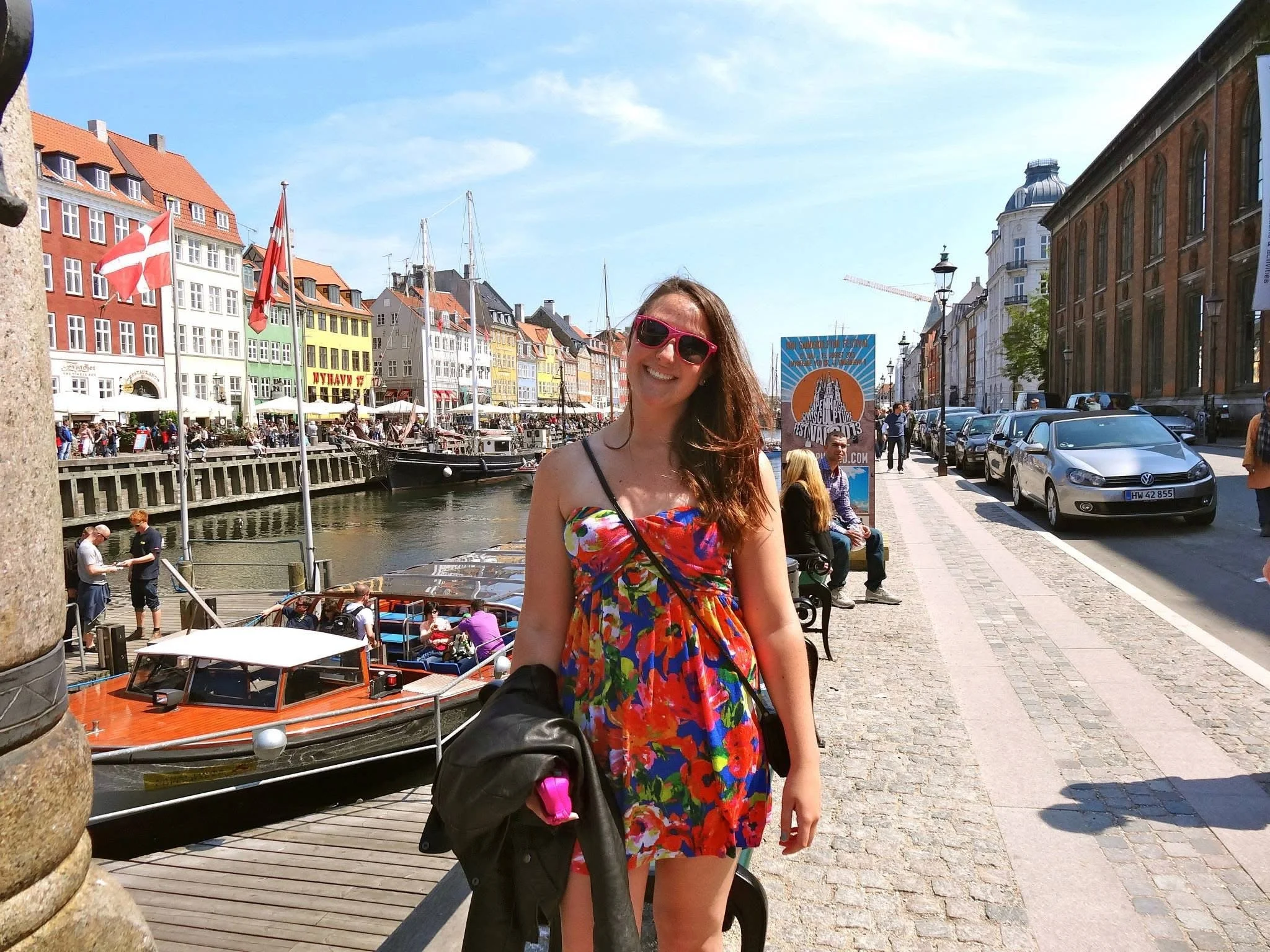 Young brunette woman in a strapless sundress at Nyhavn, Copenhagen, Denmark