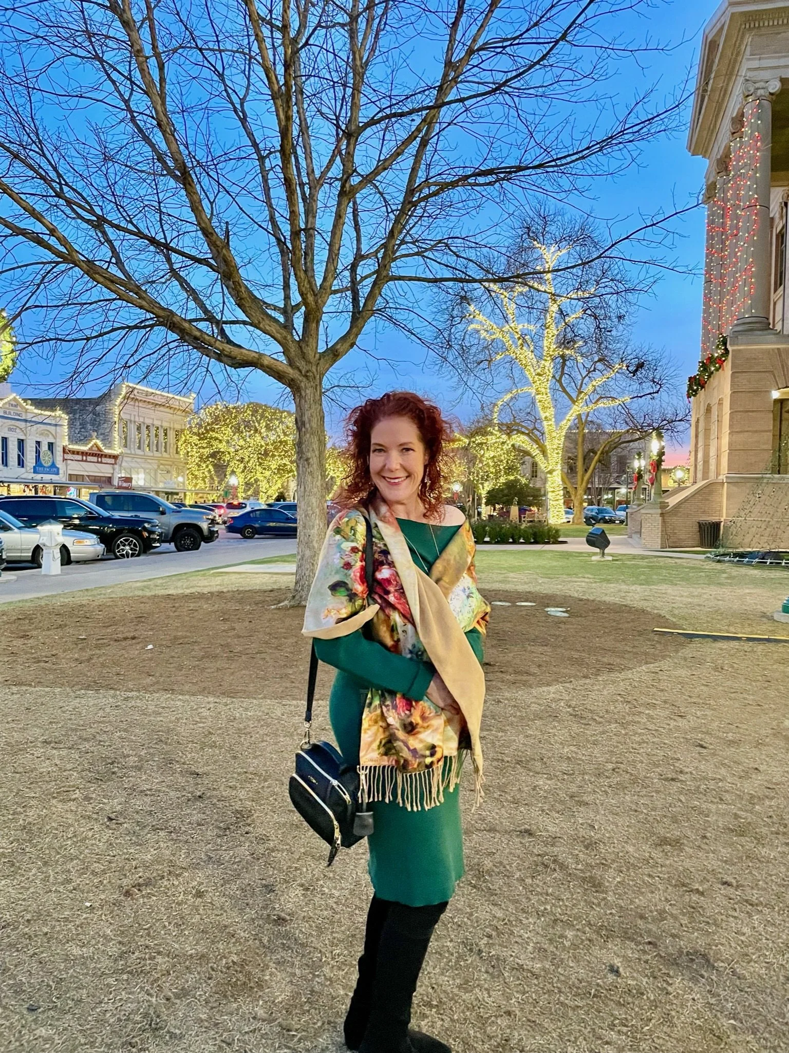 Amanda Bacqué in Georgetown Texas historic square with trees wrapped in white lights January 2023.
