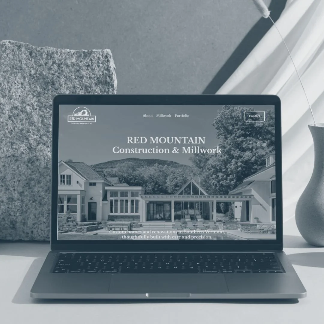 Laptop screen showing the custom home builder website Battenkill Marketing designed for Red Mountain Construction & Millwork