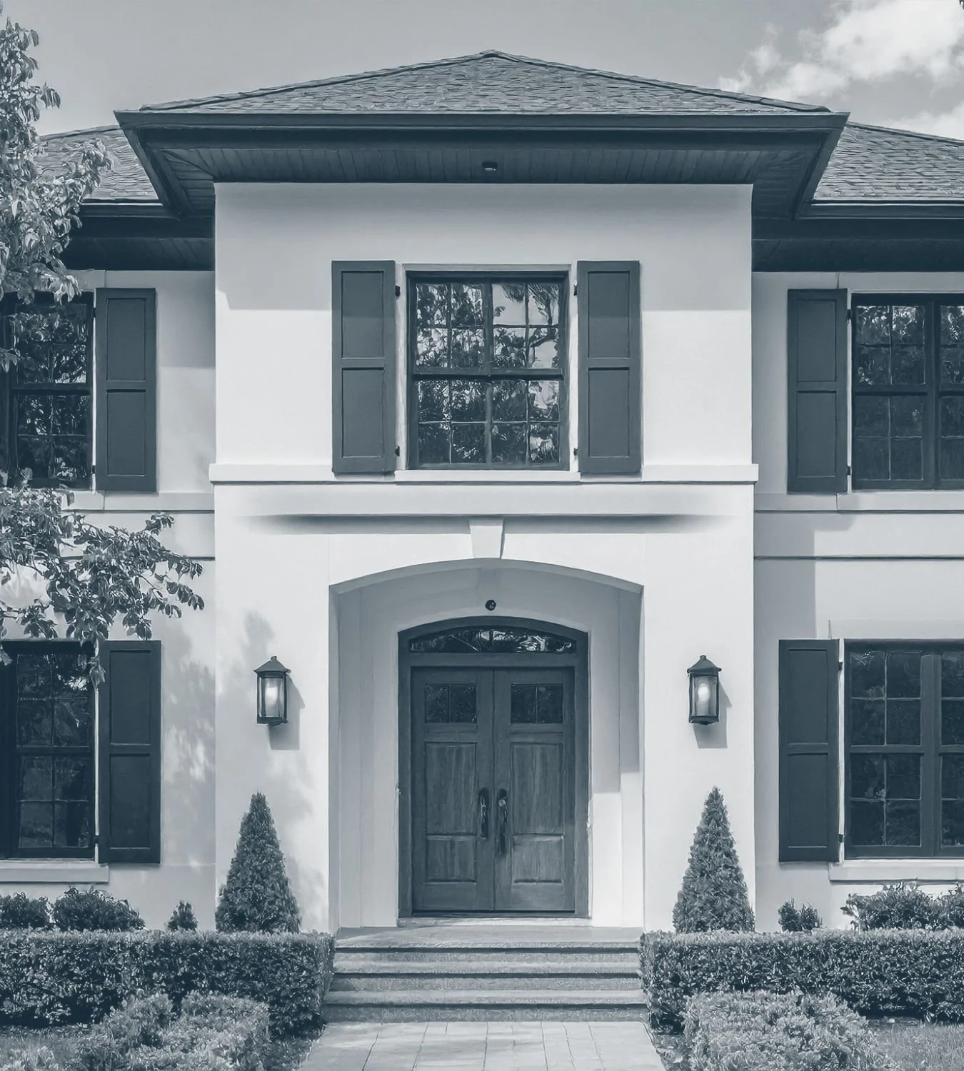 Arched front entrance of a traditional custom-built home — website design services for custom home builders