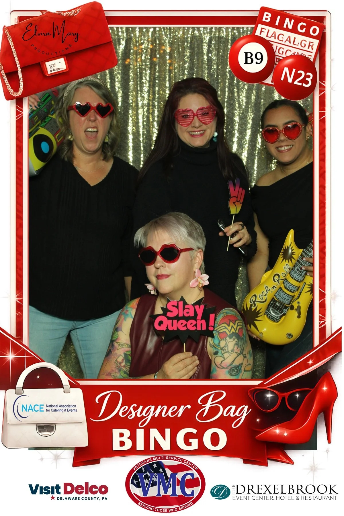 Four women wearing playful sunglasses and posing with props at a Designer Bag Bingo photo booth.