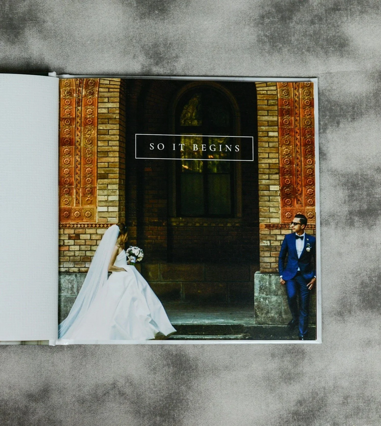 Bride and groom posing outside a building entrance on their wedding day.