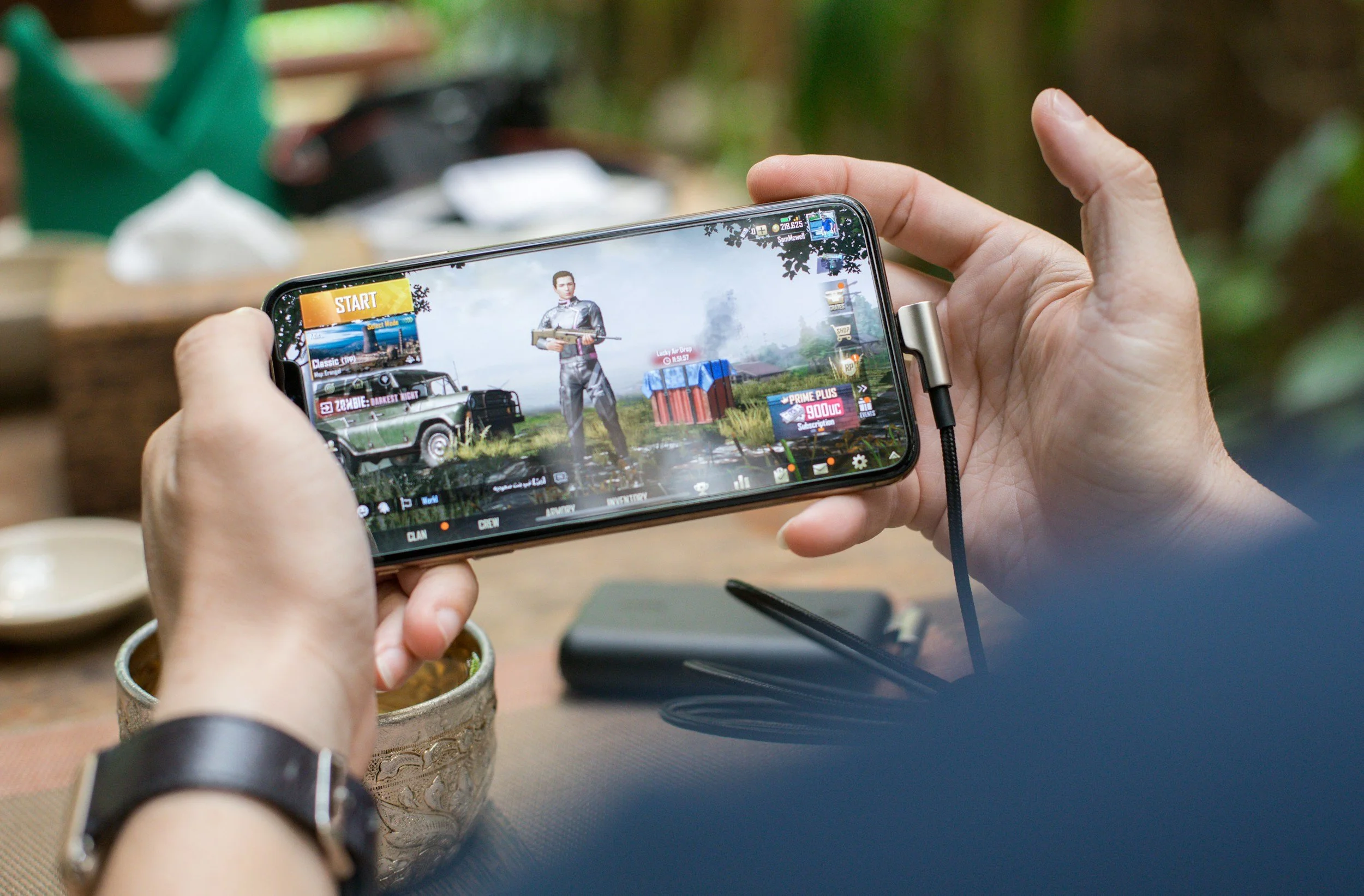 Person holding a smartphone displaying a game.