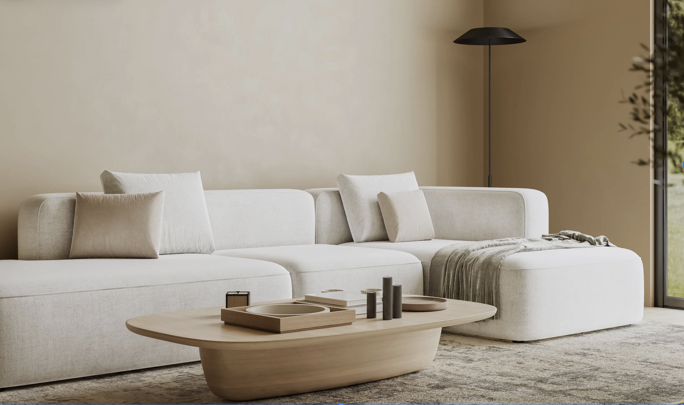 A modern living room with a white sofa, beige pillows, a round wooden coffee table with decorative items, a tall black floor lamp, and a large window with a view of greenery.