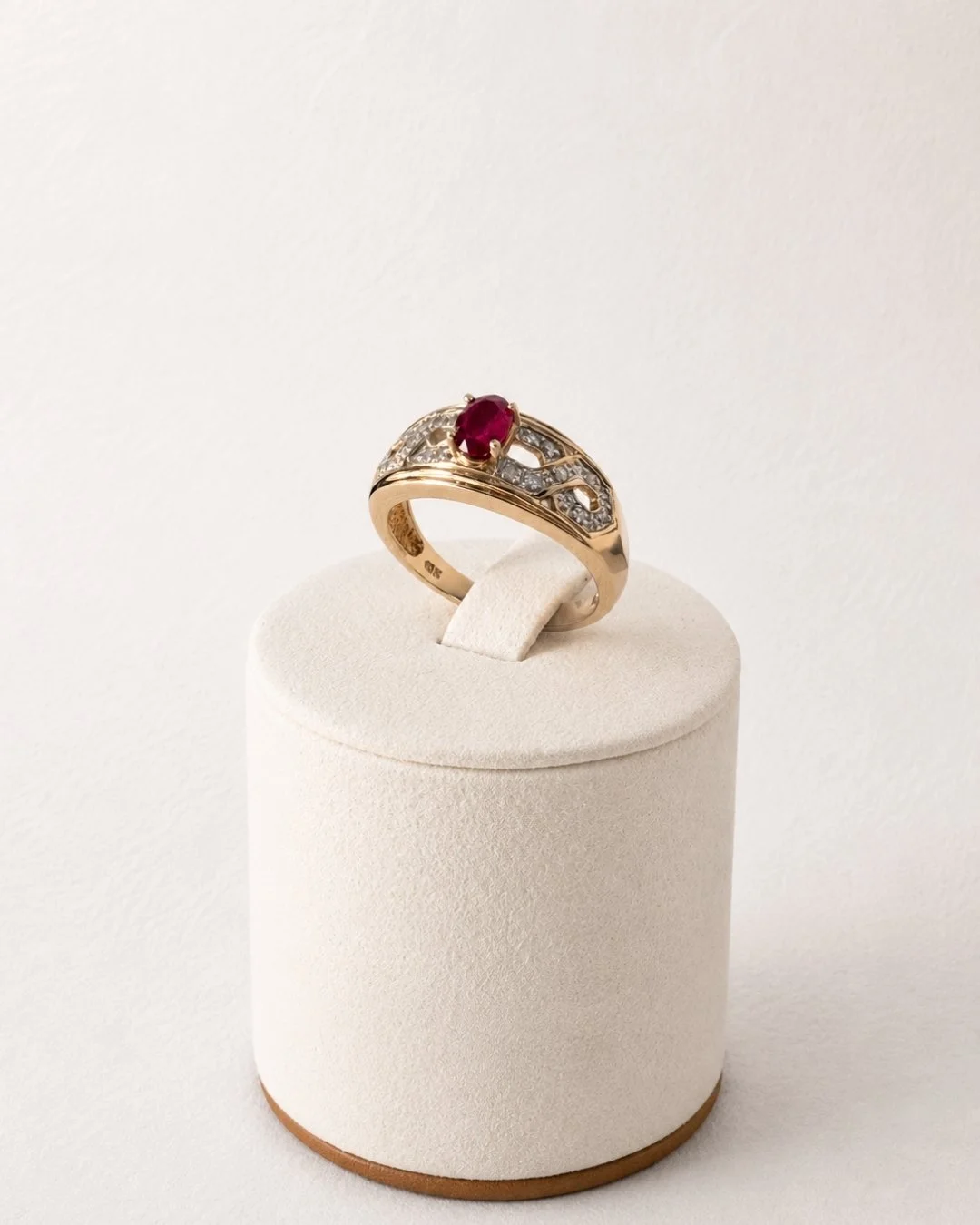 Close-up of a vintage 10ct gold ruby and diamond ring worn on the hand - Vallora Vintage