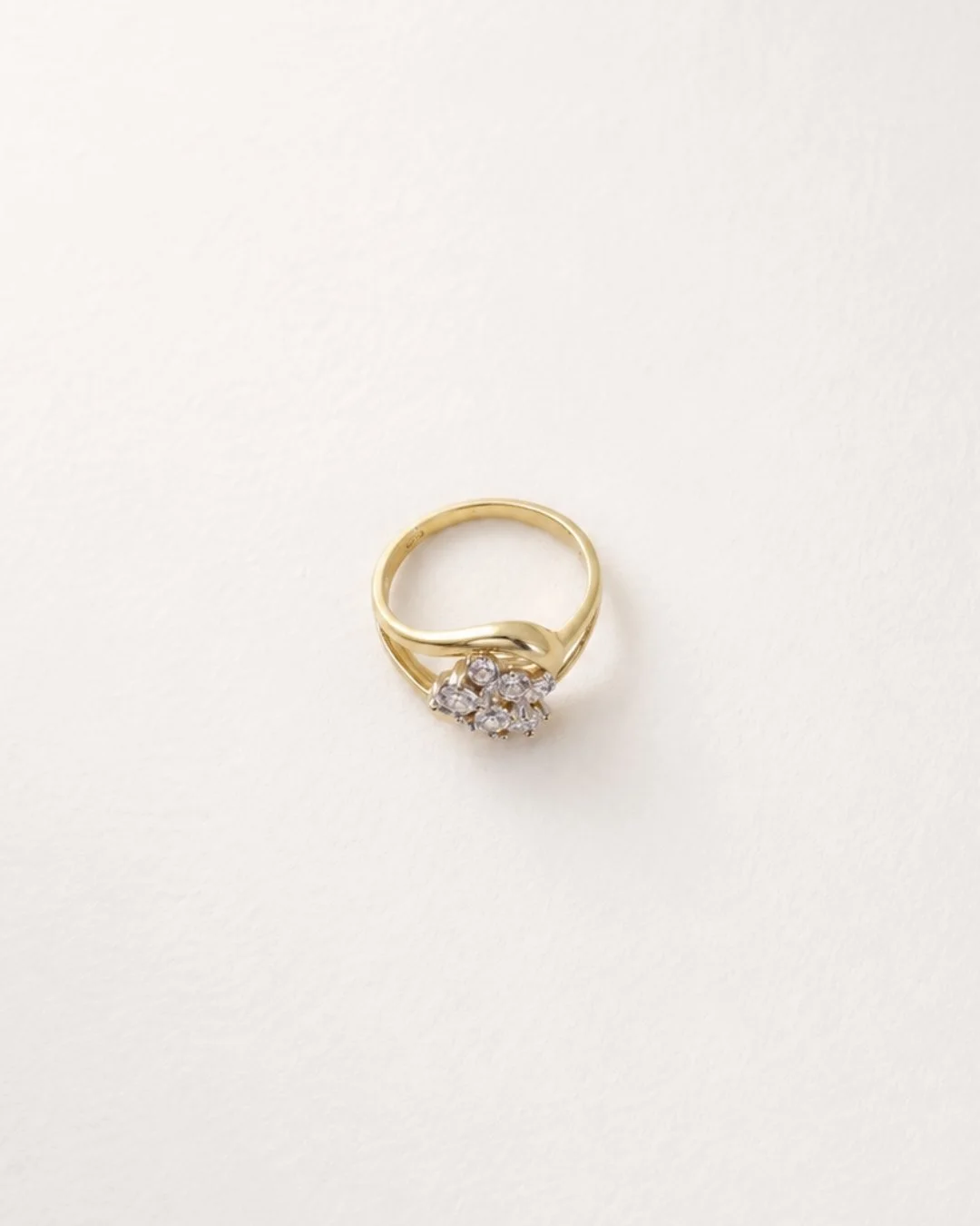 Top-down view of the vintage gold diamond cluster ring, showing the pave stones arranged to resemble one large diamond