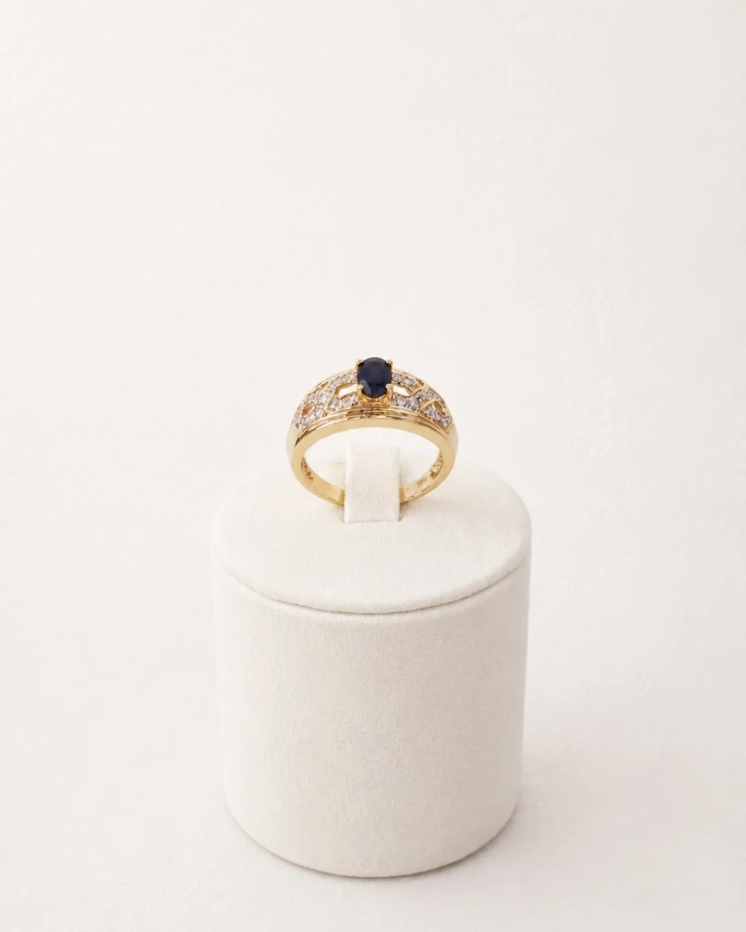 Vintage 10ct gold sapphire and diamond ring, front view on display stand - Vallora Vintage