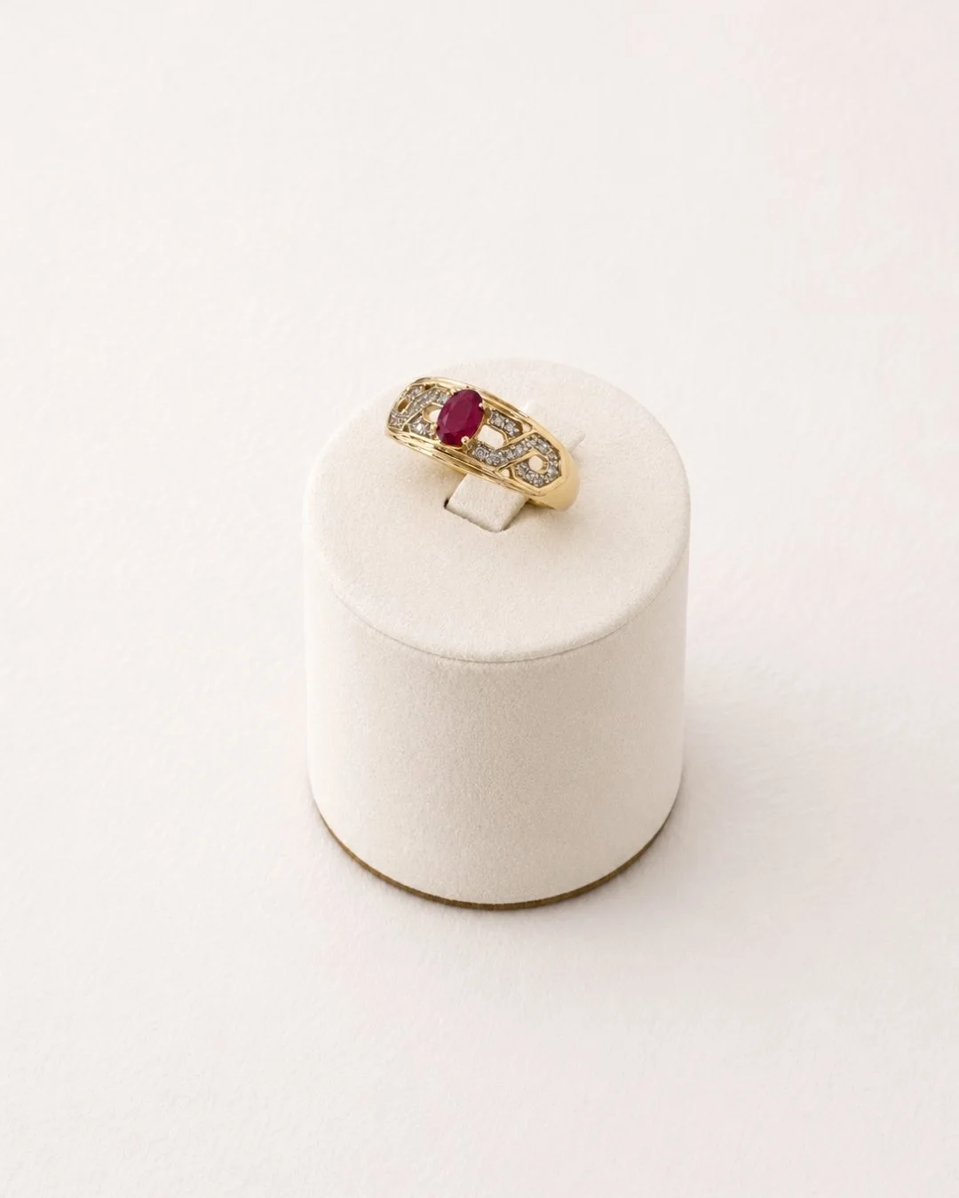 Vintage 10ct gold ruby and diamond ring, front view on display stand - Vallora Vintage