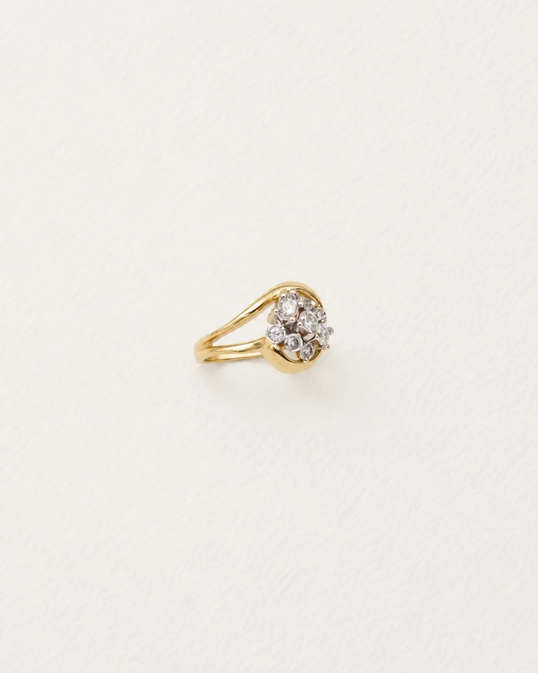 Angled view of the vintage gold diamond cluster ring highlighting the pave stone detail