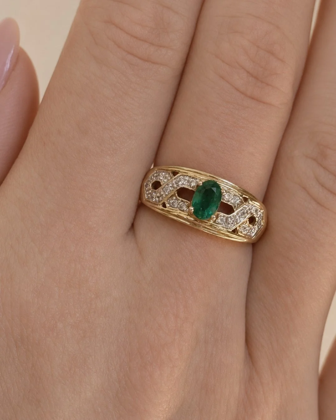 Woman wearing a vintage 10ct gold emerald and diamond ring on her finger - Vallora Vintage