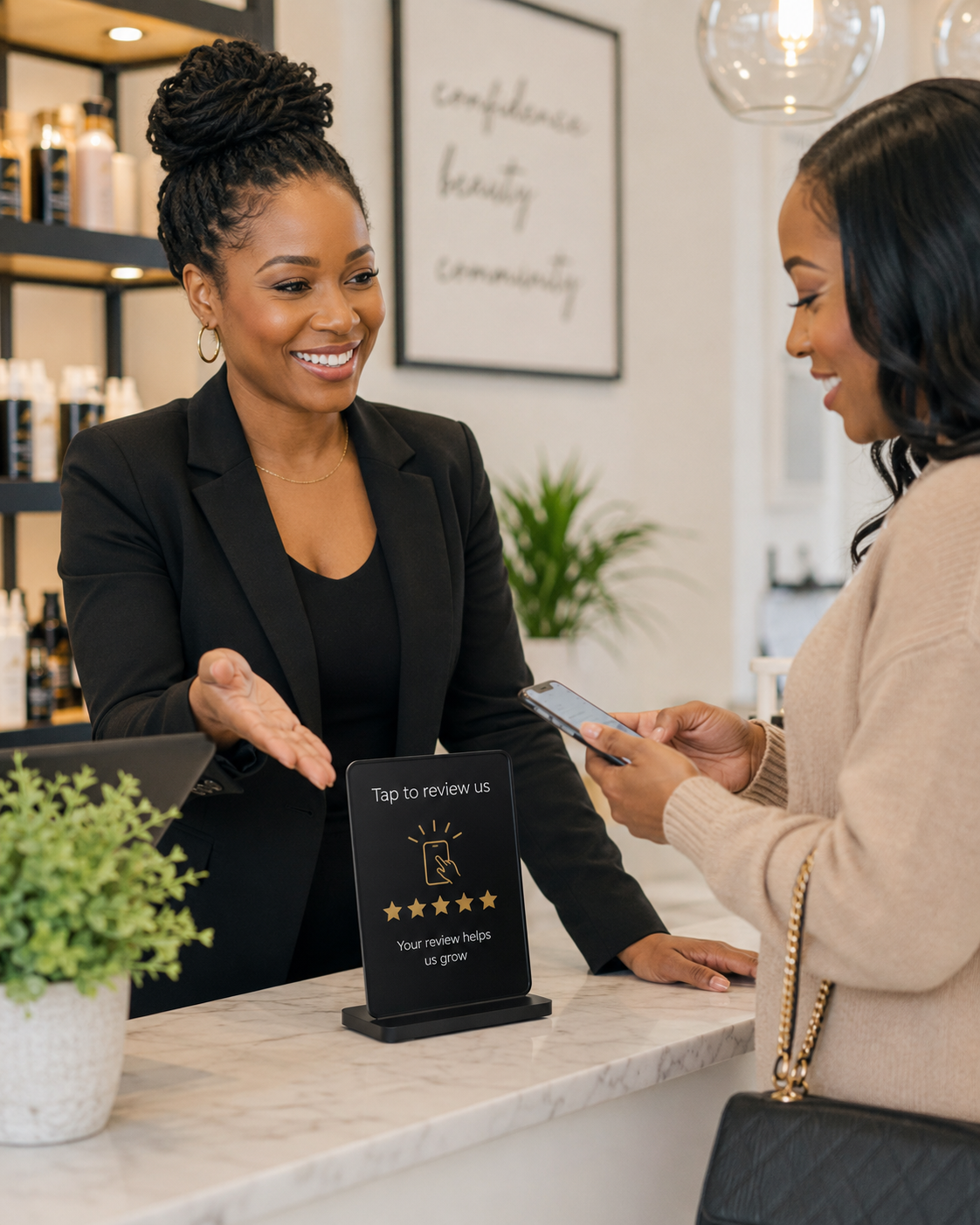 Black business owner helping a customer leave a Google review at a beauty and wellness business.
