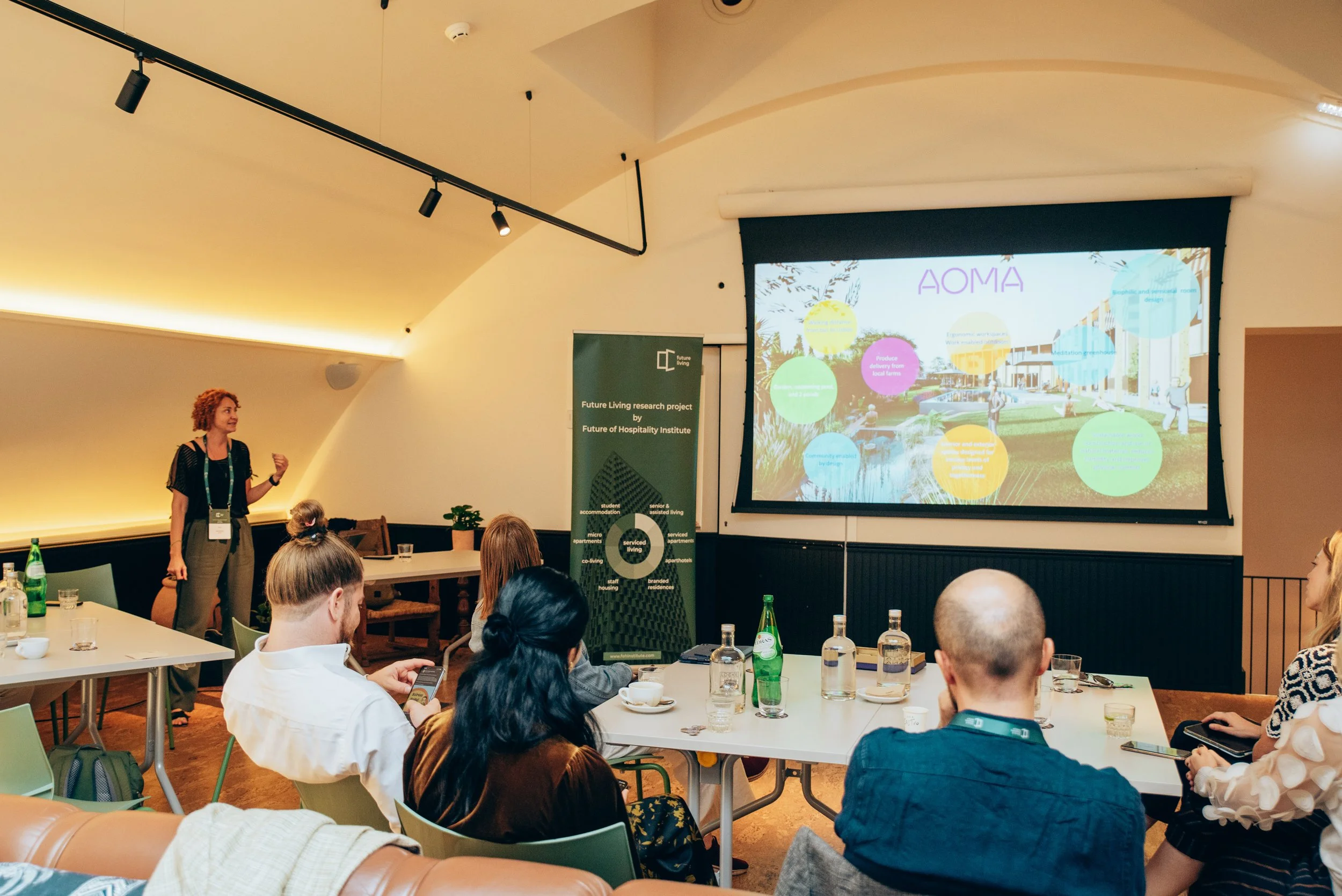 Kate Shifman giving a presentation to the Future of Hospitality group in a conference room.