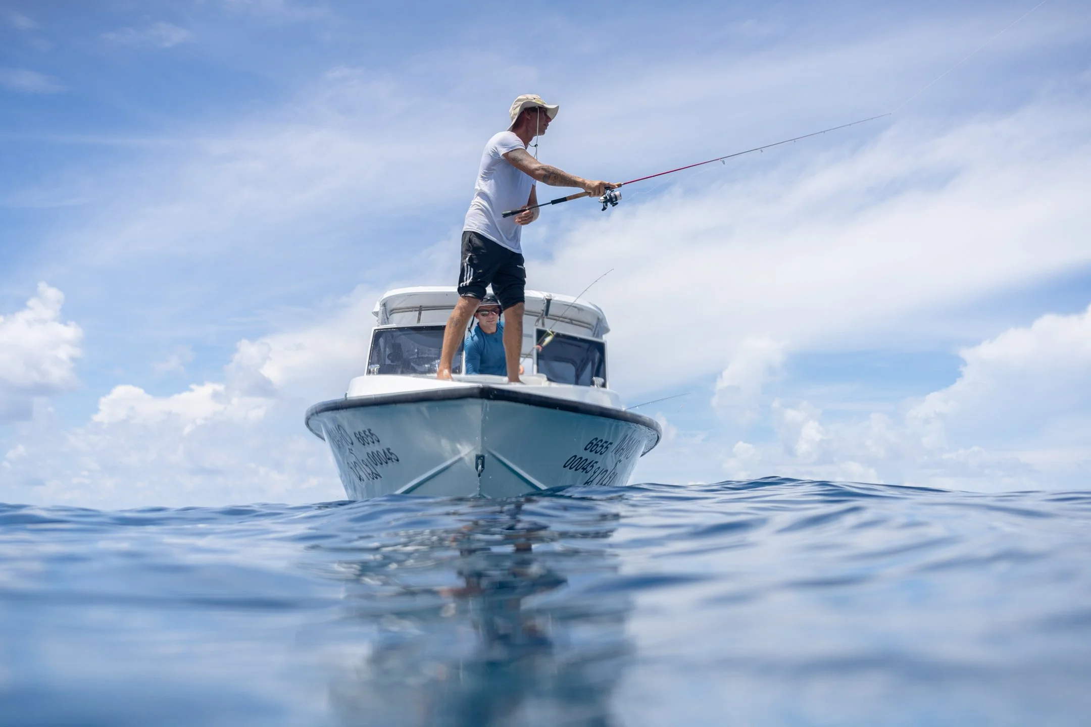 NAMA Fishing Expeditions private boat anchored in turquoise water