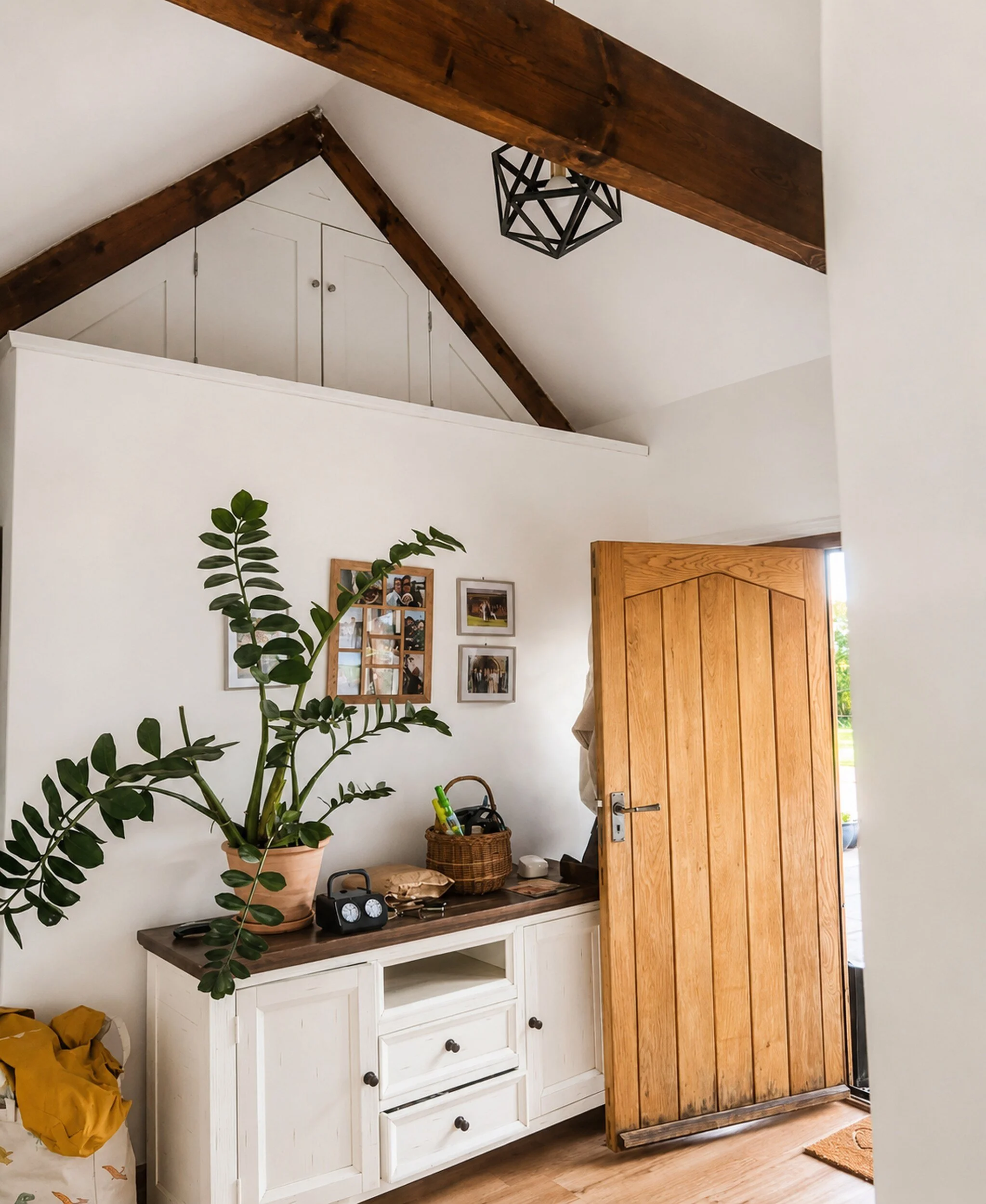 Freshly painted white walls in a converted barn interior with exposed timber beams.
