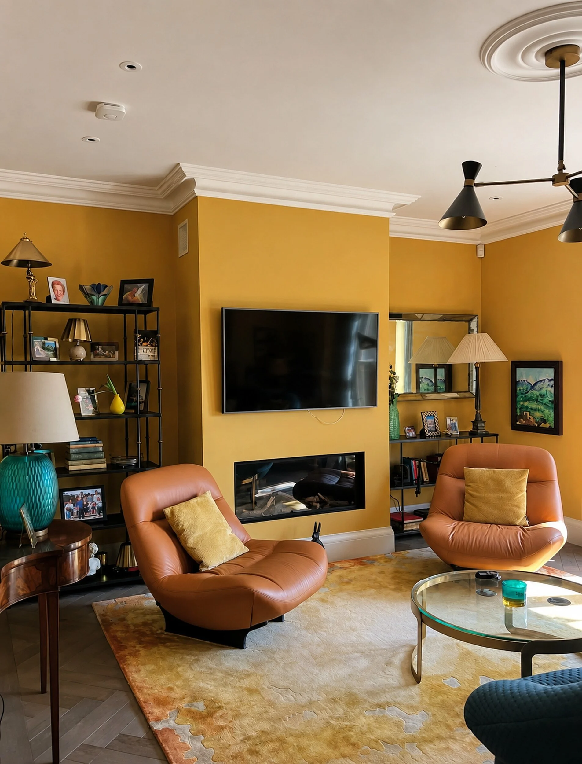 Mustard-painted living room following patch repairs to channels cut for new electrical wiring.